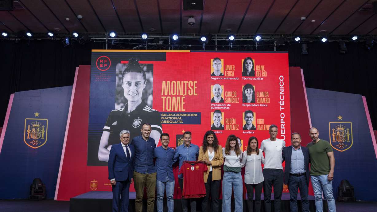 Spain's new women's national team coach Montse Tome, center, holds a jersey during her official presentation with her technical staff at the Spanish soccer federation headquarters in Las Rozas, just outside of Madrid, Spain, Monday, Sept. 18, 2023. Tome replaced Jorge Vilda less than three weeks after Spain won the Women's World Cup title and amid the controversy involving suspended federation president Luis Rubiales who has now resigned.