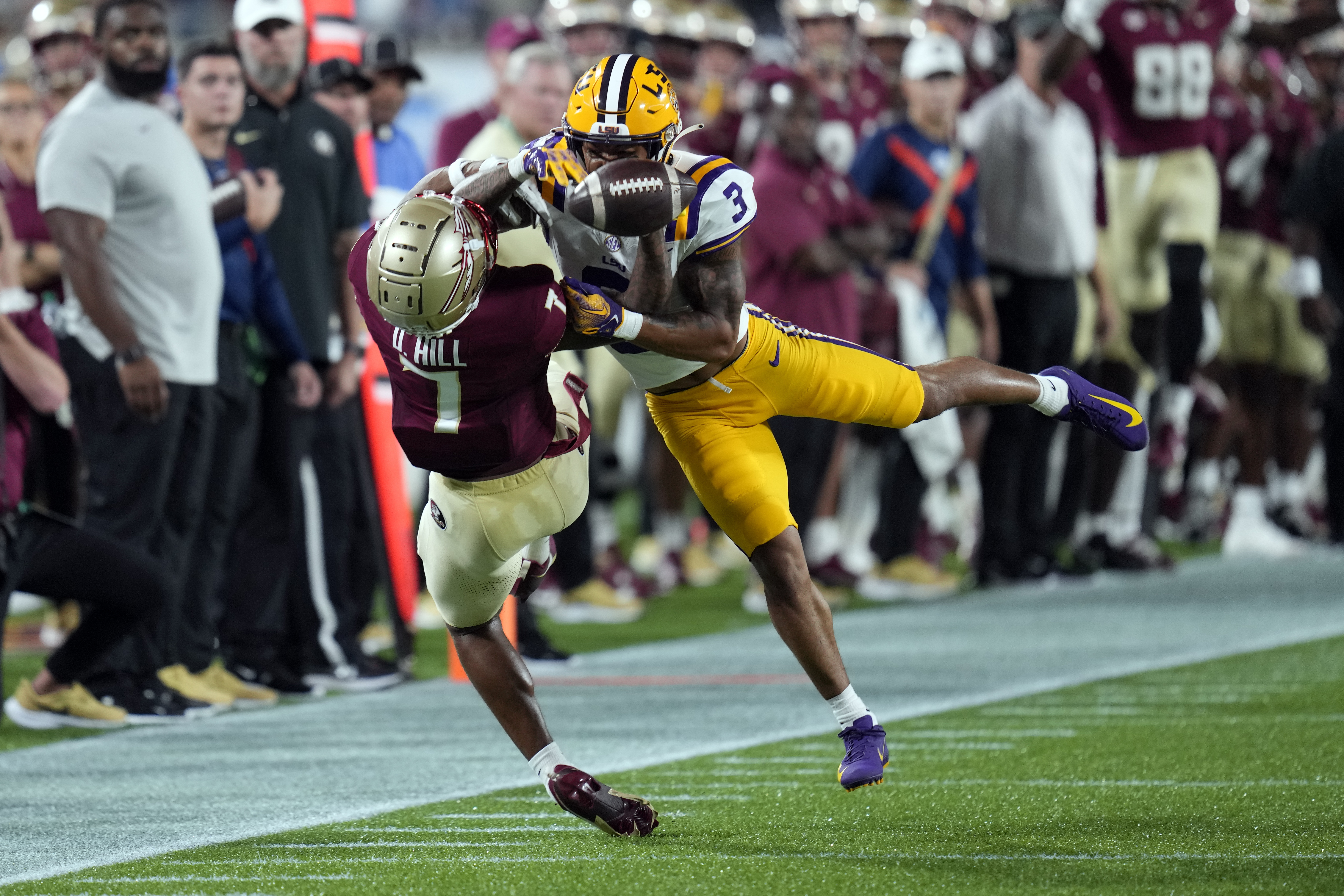 LSU safety Greg Brooks Jr. (3) breaks up a pass intended for Florida State wide receiver Destyn Hill, left, during the first half of an NCAA college football game, Sunday, Sept. 3, 2023, in Orlando, Fla. 
