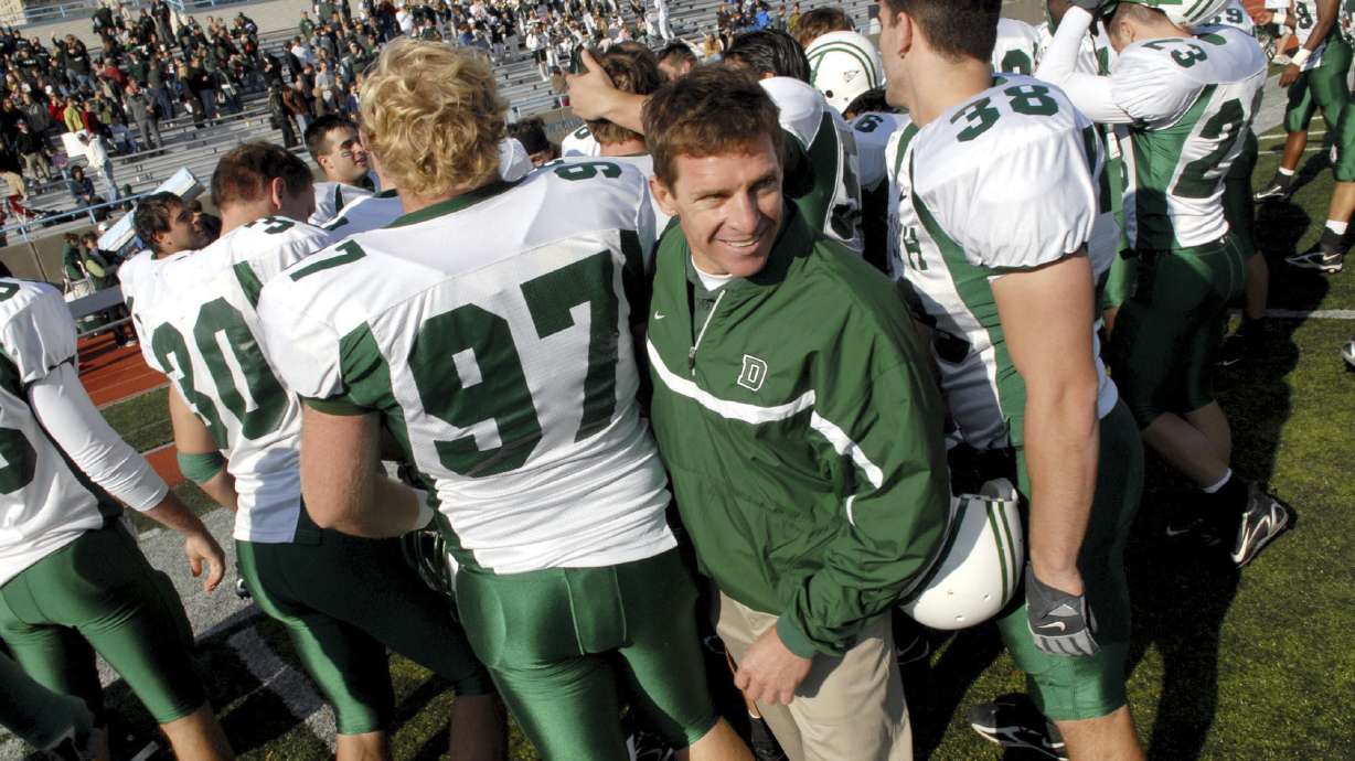 FILE - Dartmouth coach Buddy Teevens celebrates with the team after a win over Columbia during college football game Oct. 21, 2006, in New York. Teevens, the innovative Ivy League football coach who brought robotic tackling dummies to Dartmouth practices, died Tuesday, Sept. 19, 2023, of injuries he sustained from a bicycle accident in March. He was 66. School president Sian Leah Beilock and athletic director Mike Harrity announced Teevens' death in a letter to the Dartmouth community.