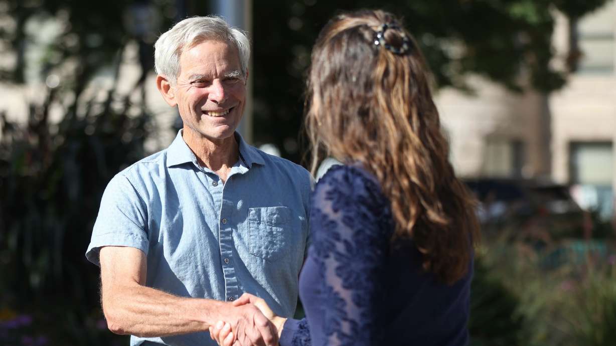 Former Salt Lake City Mayor Ralph Becker, left, shakes hands with Salt Lake City Mayor Erin Mendenhall during a campaign event outside of the Salt Lake City-County Building Wednesday. Becker said he's voting for Mendenhall in November.