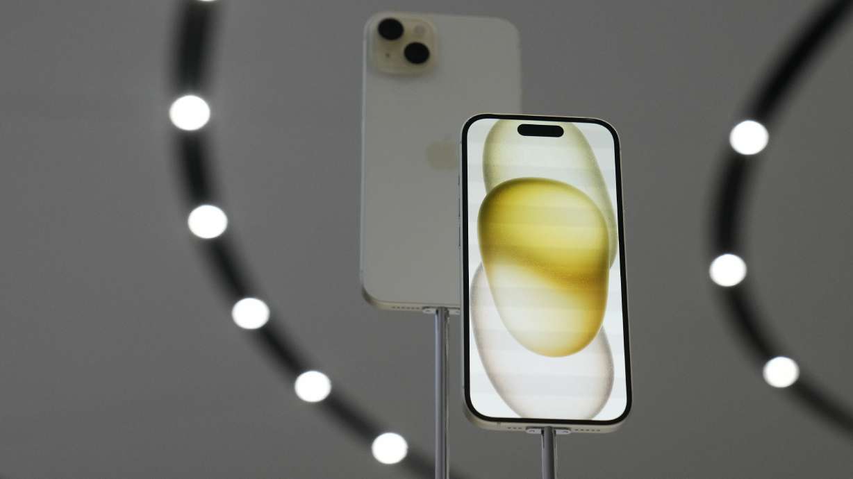The iPhone 15 phones are shown on the Apple campus in Cupertino, Calif., Tuesday. Choosing the right plan to go with the snazzy new device can save consumers thousands of dollars.