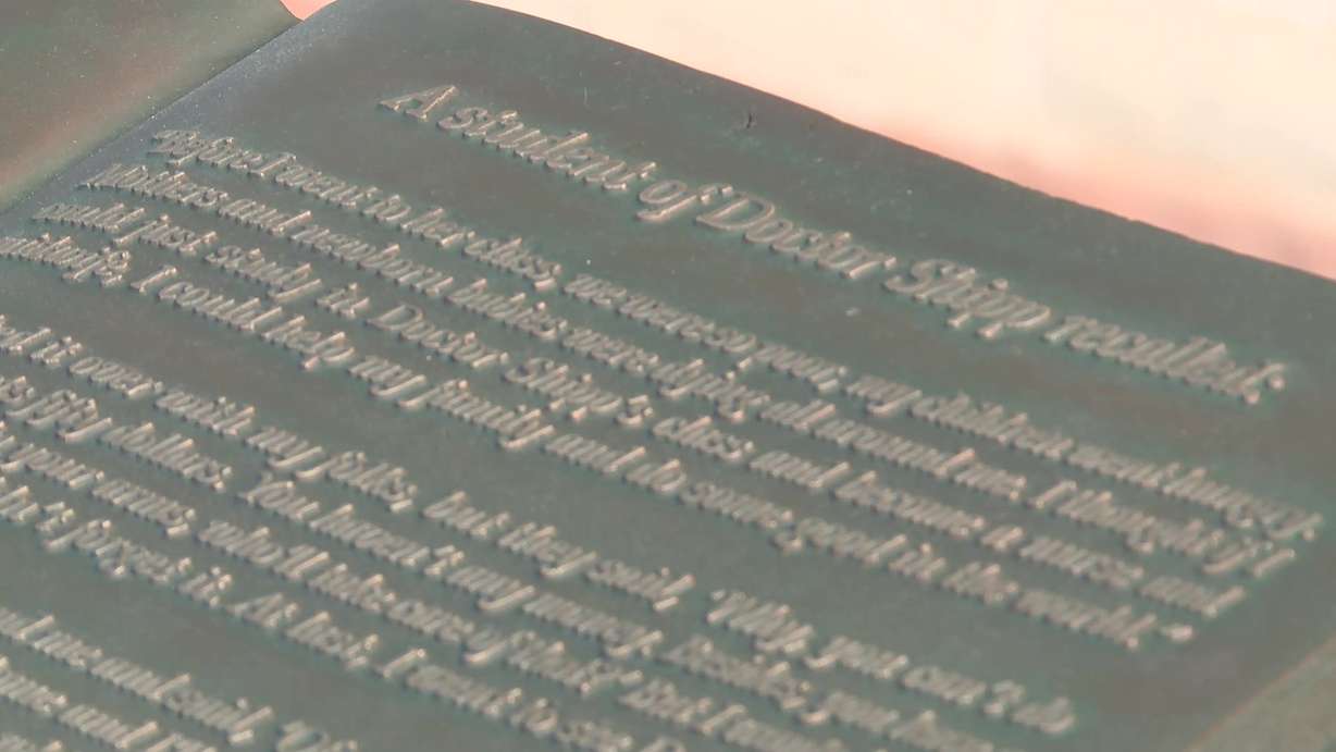 The text embedded in the book that the statue of Dr. Ellis Reynolds Shipp is holding.
