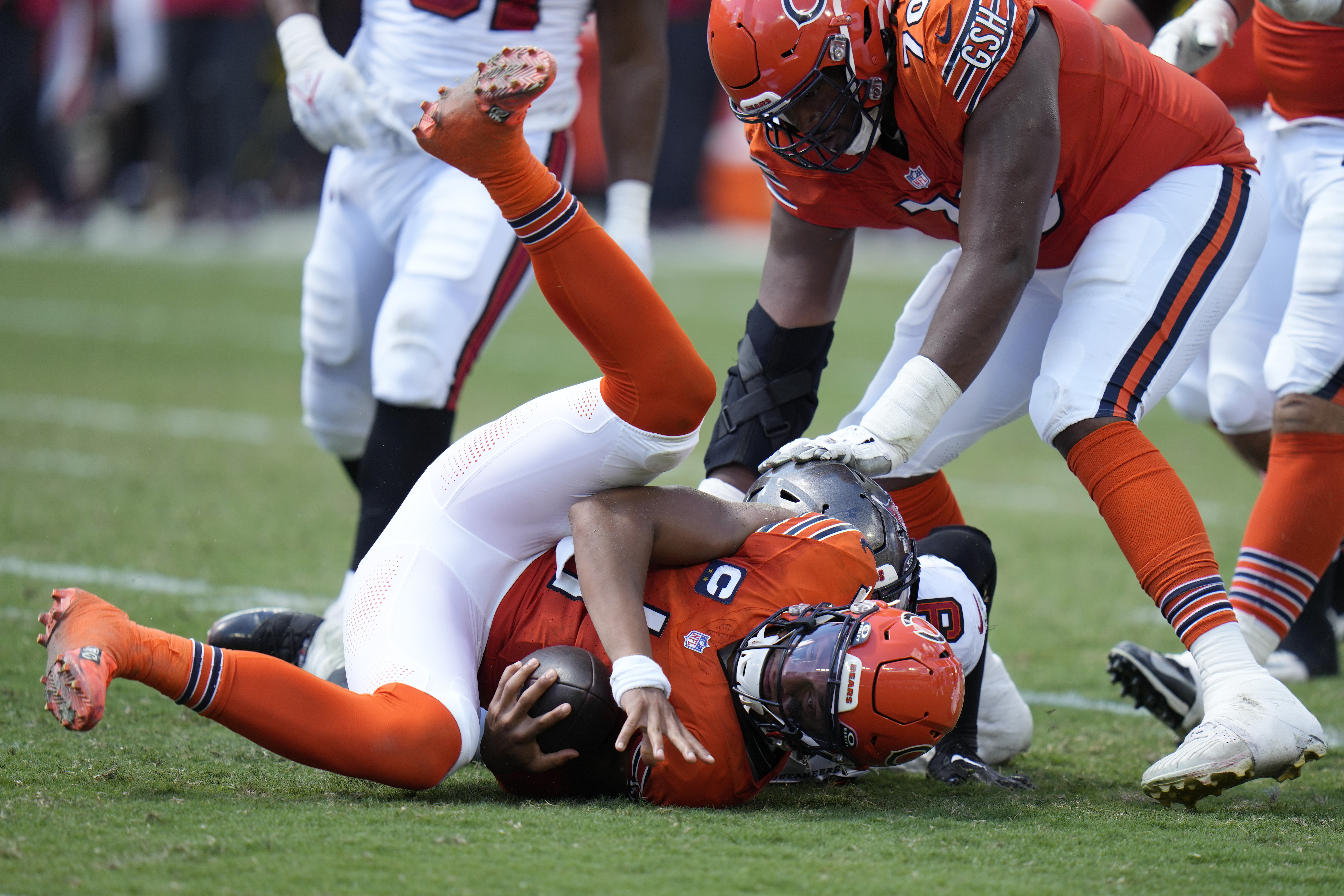 Chicago Bears quarterback Justin Fields (1) is sacked by Tampa Bay Buccaneers linebacker Joe Tryon-Shoyinka (9) during the second half of an NFL football game, Sunday, Sept. 17, 2023, in Tampa, Fla.