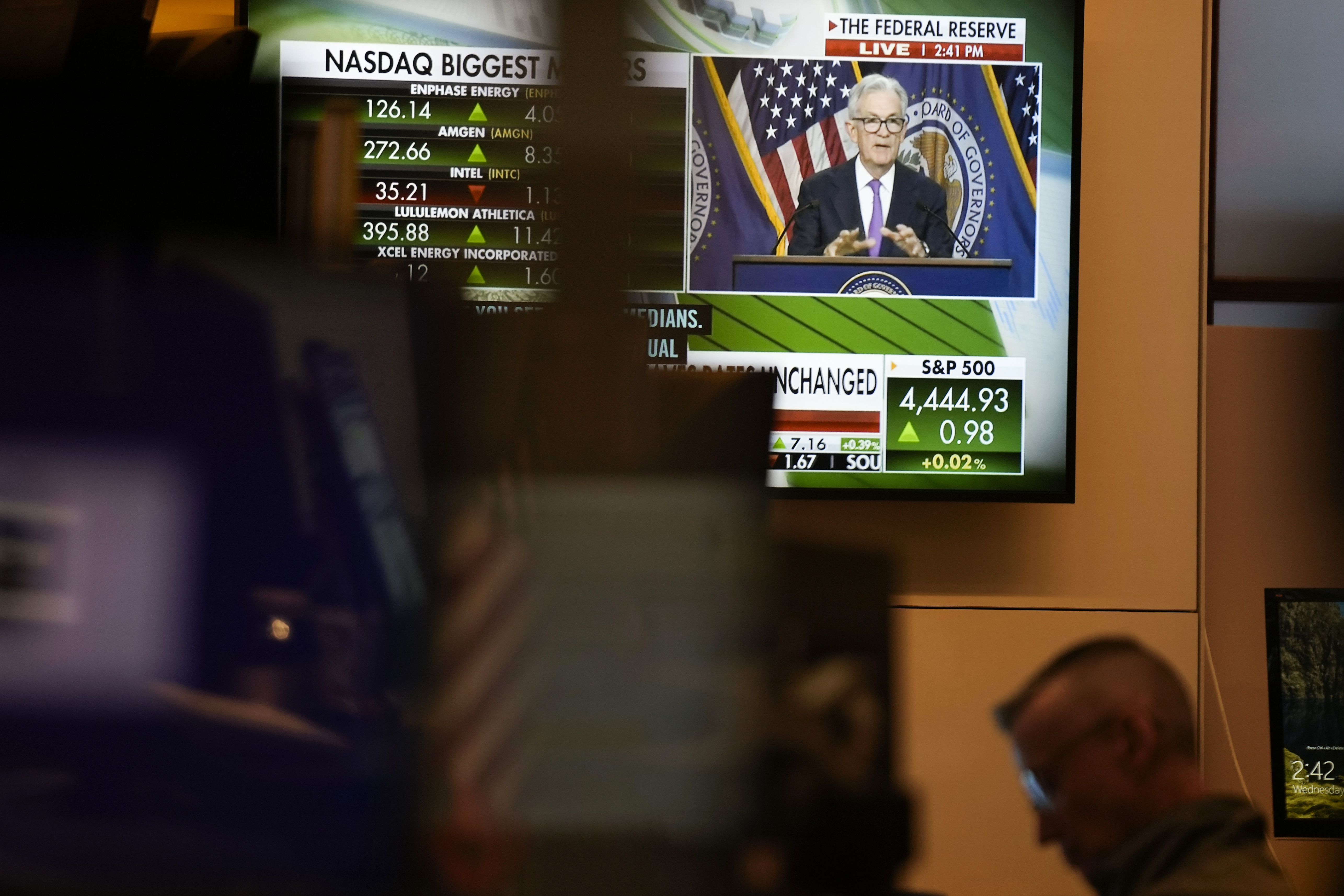 A press conference by Federal Reserve Chairman Jerome Powell is displayed on the floor at the New York Stock Exchange in New York, Wednesday. The Federal Reserve left its key interest rate unchanged for the second time in its past three meetings.