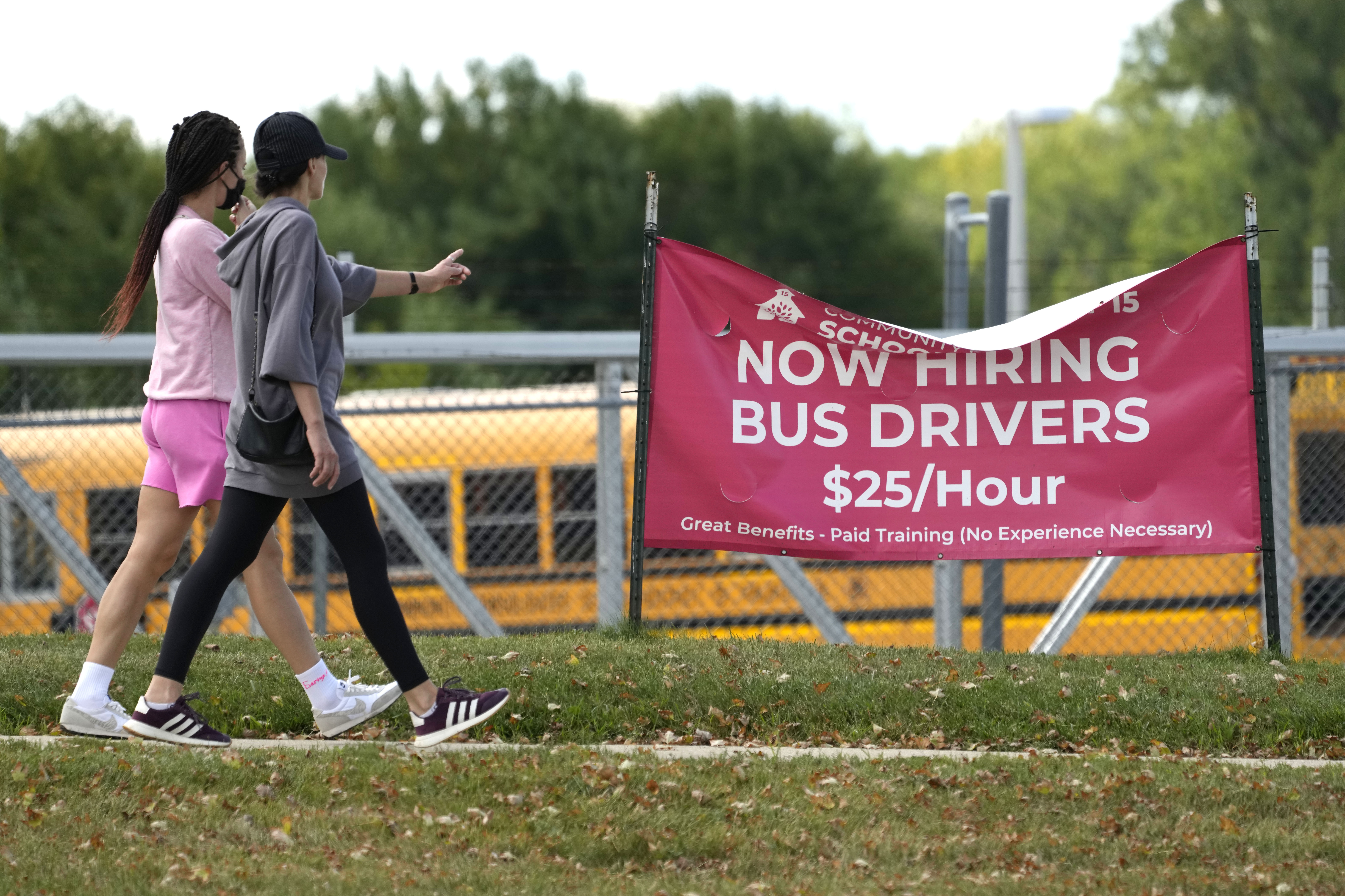 A sign advertising jobs for bus drivers is posted in Palatine, Ill., Sept. 13. On Thursday, the Labor Department reported on the number of people who applied for unemployment benefits last week.