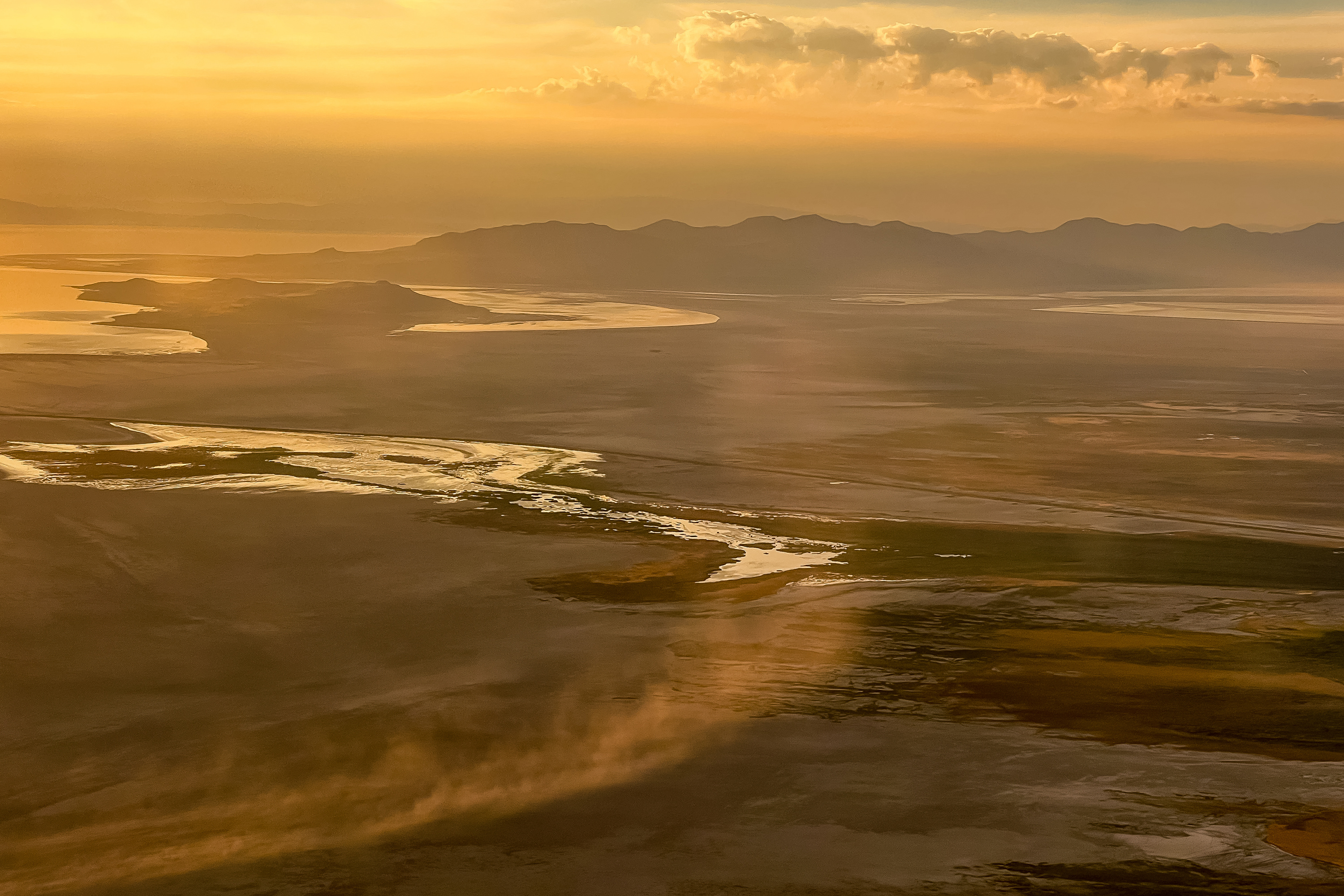 Dust blows across the dry lakebed of the Great Salt Lake near Salt Lake City on Aug. 12, 2022. Utah hopes to have a network of air quality monitors set up soon that could help researchers better understand the lake's dust.