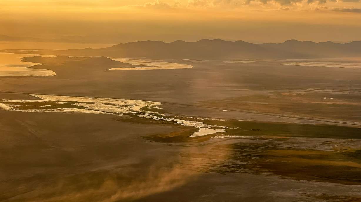 Dust blows across the dry lakebed of the Great Salt Lake near Salt Lake City on Aug. 12, 2022. Utah's top air quality official said Monday that Great Salt Lake's dust is still a "potential problem," but it's one he said the state wants to address.