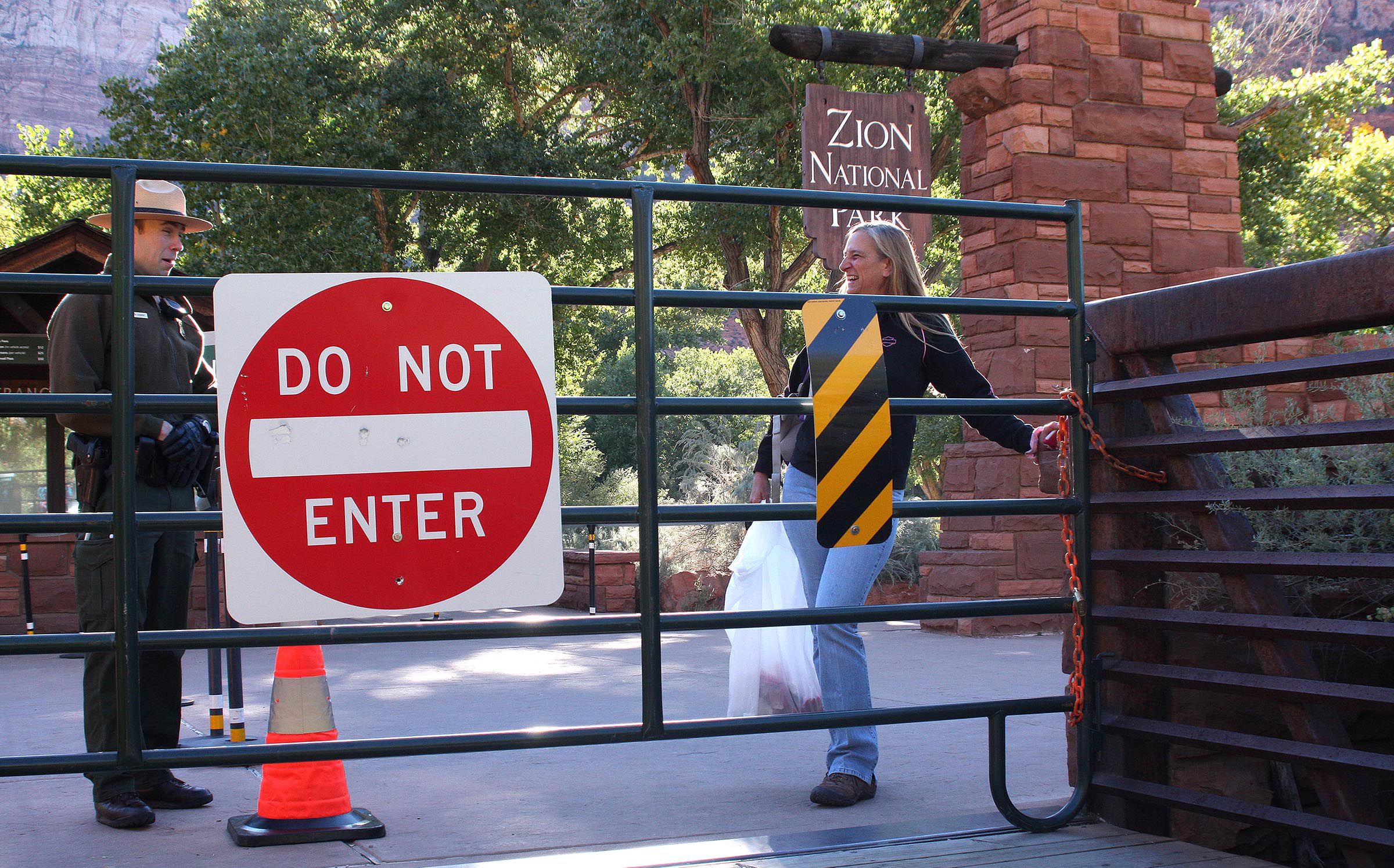 Park Ranger Matthew Chuvarsky talks to St. George resident Melissa Norris on Oct. 5, 2013, about her hike in Zion National Park that violated the park’s closure after the government shutdown. Is another federal shutdown looming, and what does Utah have planned to address it?