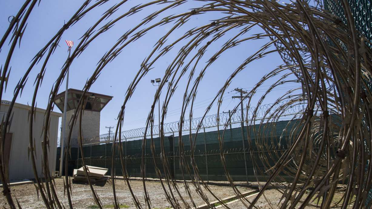 In this April 17, 2019, photo, reviewed by U.S. military officials, the control tower is seen through the razor wire inside the Camp VI detention facility in Guantanamo Bay Naval Base, Cuba. A military medical panel has concluded that one of the five 9/11 defendants held at Guantanamo Bay has been rendered delusional and psychotic by the torture he underwent years ago while in CIA custody.
