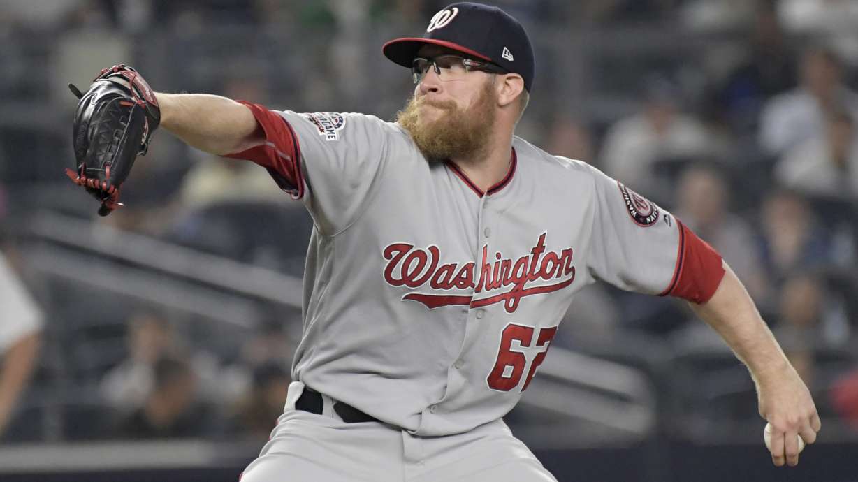 FILE - Washington Nationals relief pitcher Sean Doolittle delivers to the New York Yankees during the ninth inning of a baseball game at Yankee Stadium in New York, June 13, 2018. Sean Doolittle has decided to retire from baseball after more than a decade pitching in the majors that included helping the Washington Nationals win the World Series in 2019. Doolittle announced his decision in a lengthy social media post Friday, Sept. 22, 2023.