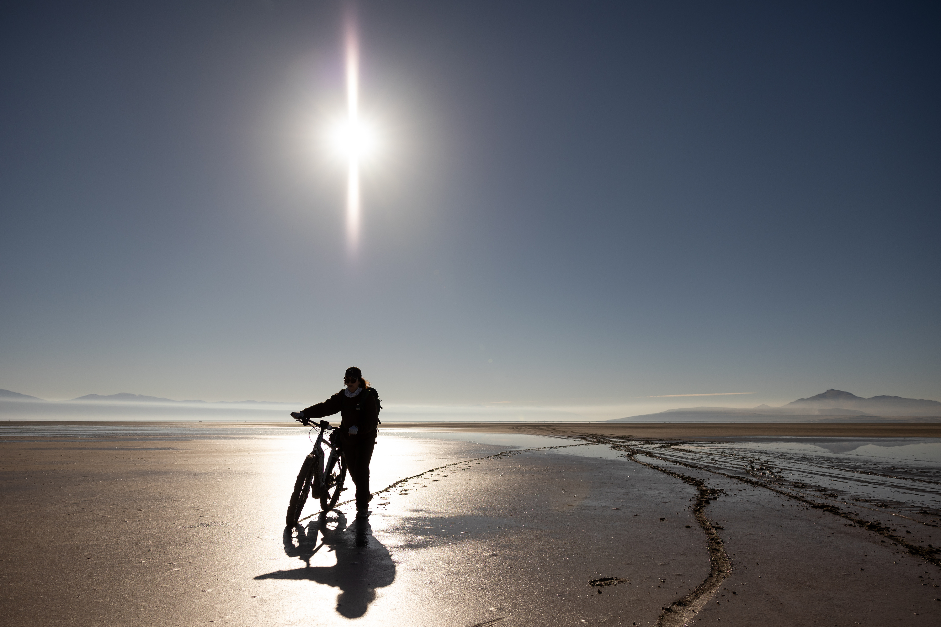 An e-bike rider walks through soft mud while using it to ride across a sandbar to Fremont Island on Oct. 21, 2021. Utah recreation officials are working to clear the "confusion" between e-bikes and e-motorcycles and what's allowed on public lands.