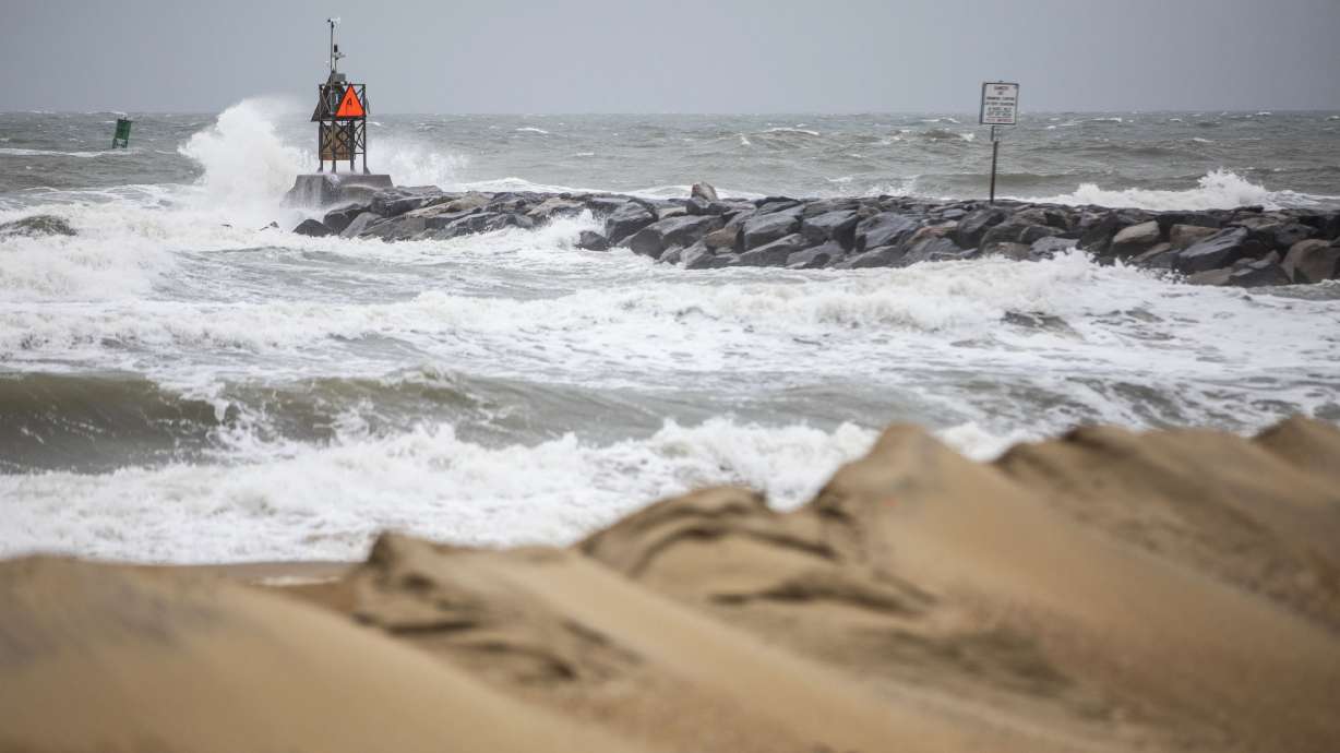 Waves break along the jetty at Rudee Inlet in Virginia Beach, Va., on Friday as Tropical Storm Ophelia approaches the area. Residents in parts of coastal North Carolina and Virginia have experienced flooding after Tropical Storm Ophelia made landfall near a North Carolina barrier island, bringing rain, damaging winds and dangerous surges.