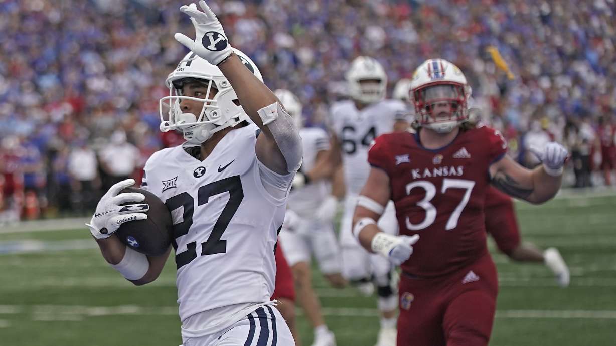 Brigham Young running back LJ Martin (27) celebrates after scoring a touchdown during the first half of an NCAA college football game against Kansas Saturday, Sept. 23, 2023, in Lawrence, Kan.