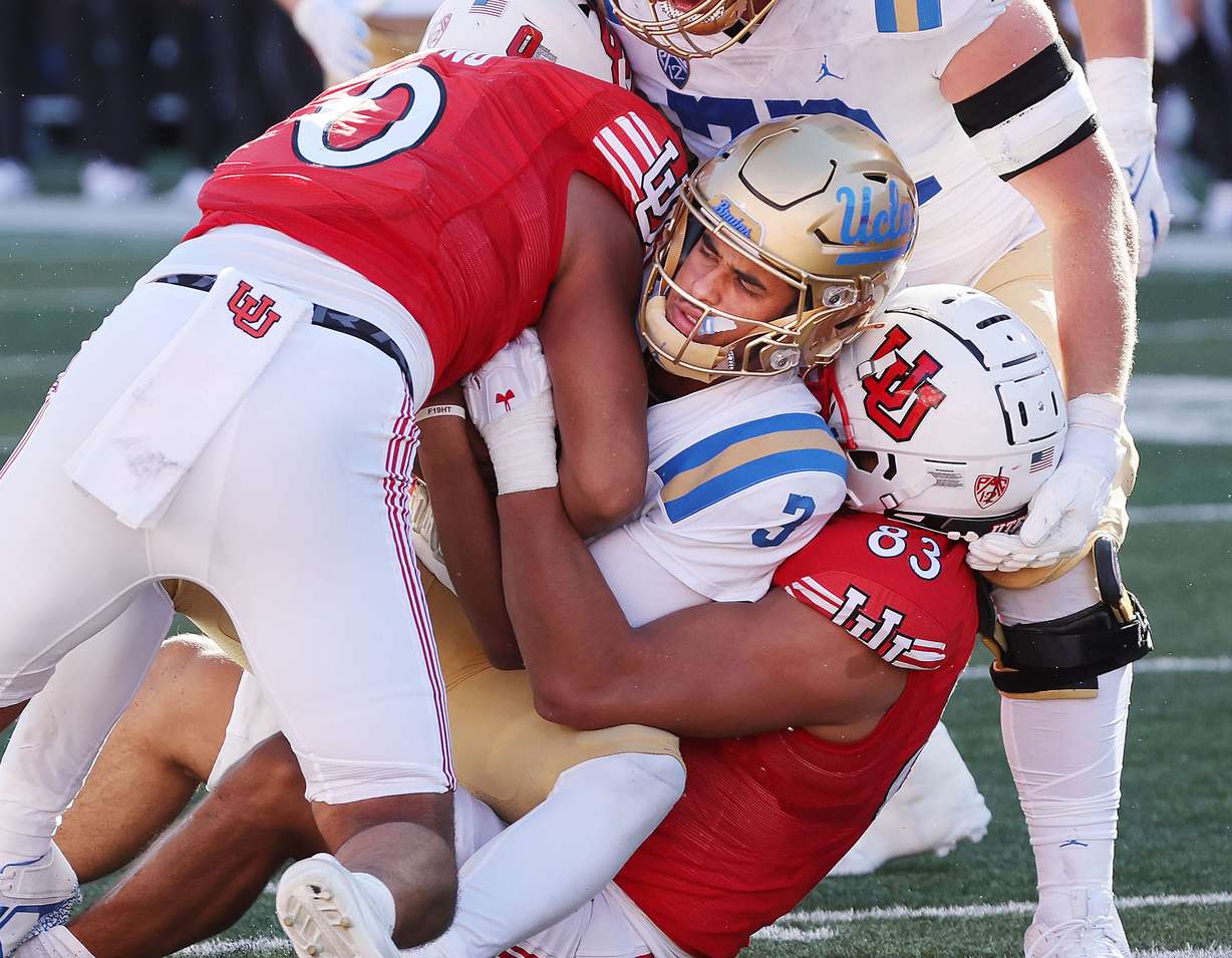 Utah Utes defensive end Jonah Elliss (83) and defensive end Logan Fano (0) sack UCLA quarterback Dante Moore (3) at the end of the game in Salt Lake City on Saturday, Sept. 23, 2023. Utah won 14-7.