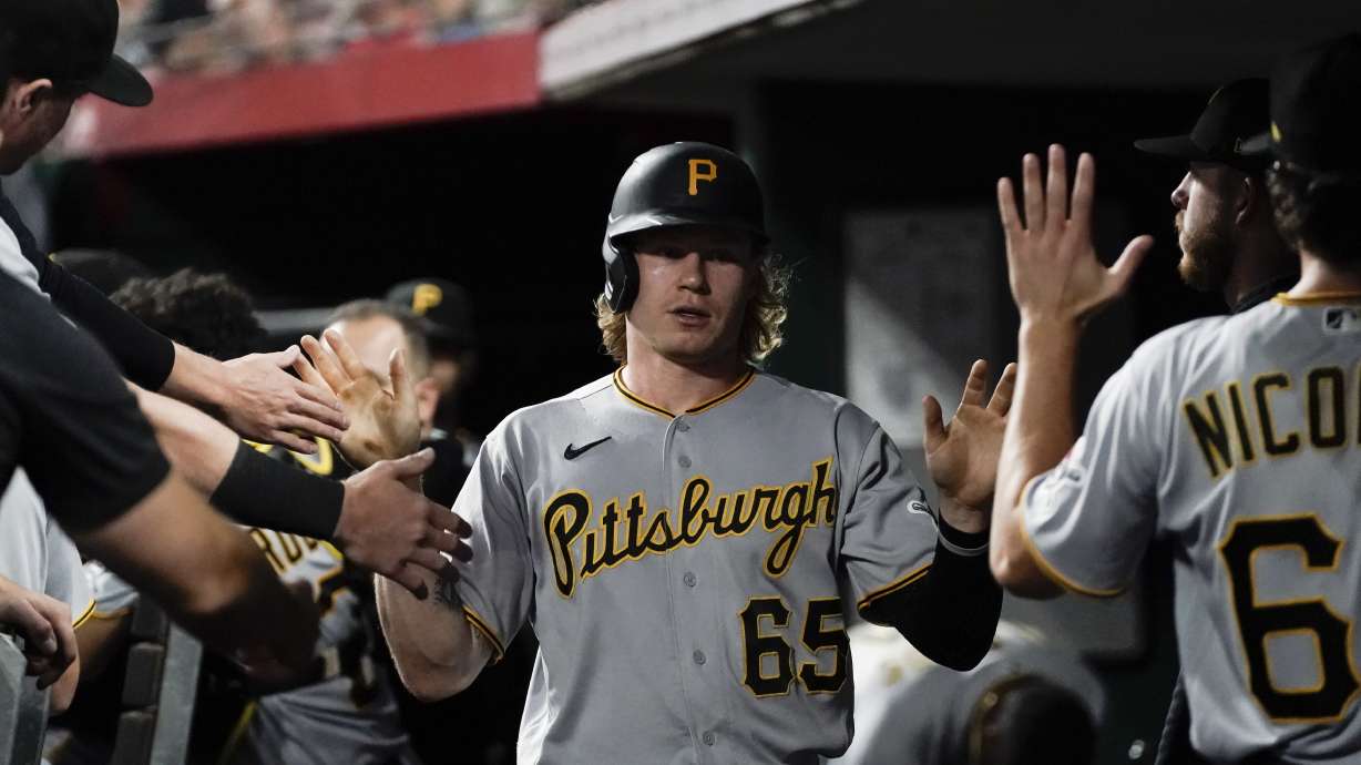 Pittsburgh Pirates' Jack Suwinski is congratulated after scoring against the Cincinnati Reds during the fourth inning of a baseball game Saturday, Sept. 23, 2023, in Cincinnati.