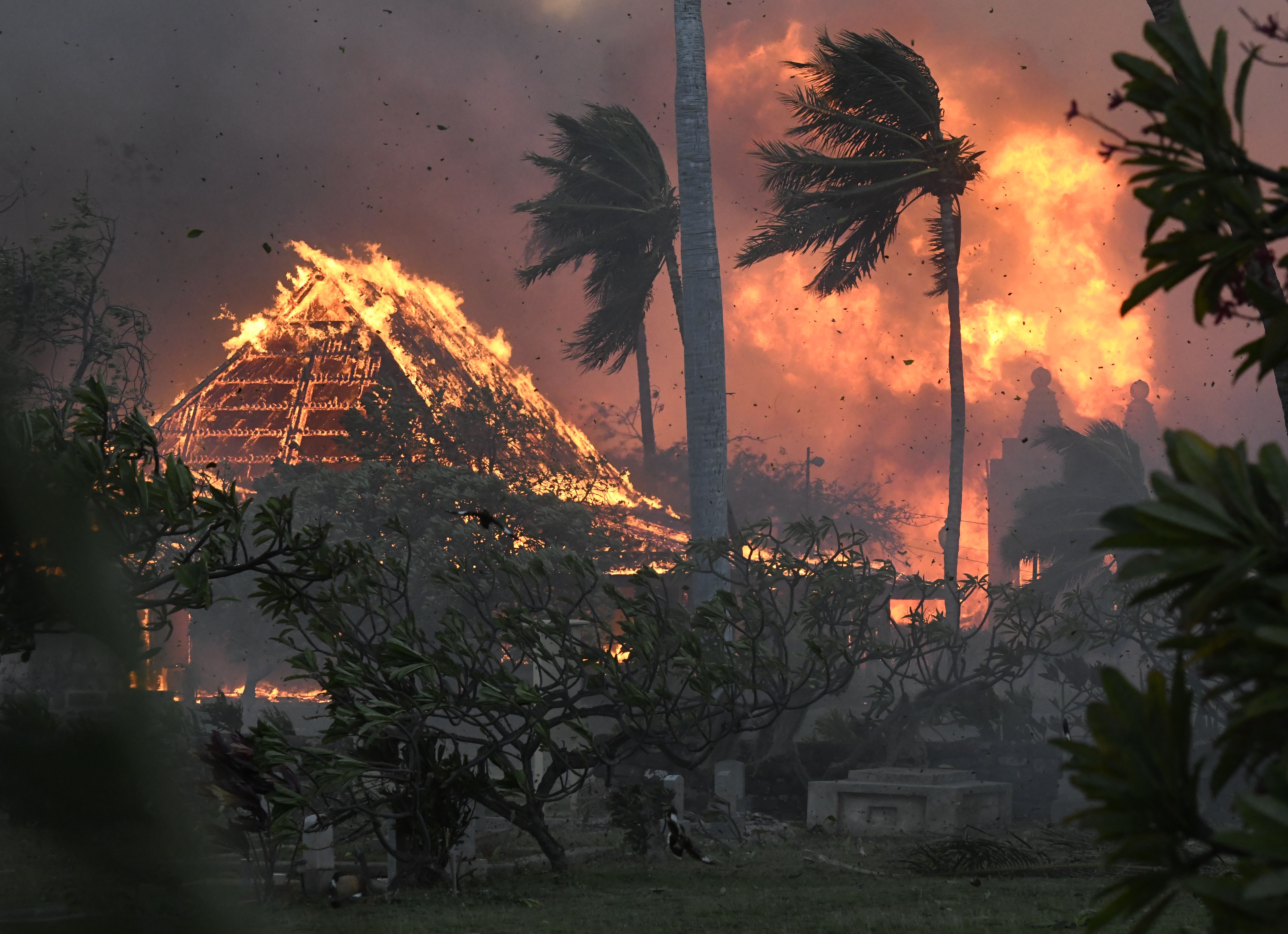 The hall of historic Waiola Church in Lahaina and nearby Lahaina Hongwanji Mission are engulfed in flames along Wainee Street on Aug. 8, in Lahaina, Hawaii. Soon after Lahaina Hongwanji Mission burned in a wildfire that decimated much of the historic coastal town, the Japanese Buddhist temple's resident minister was desperate to go back and see what remained.