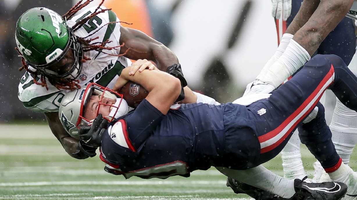 New England Patriots quarterback Mac Jones (10) is sacked by New York Jets linebacker C.J. Mosley (57) during the fourth quarter of an NFL football game, Sunday, Sept. 24, 2023, in East Rutherford, N.J.