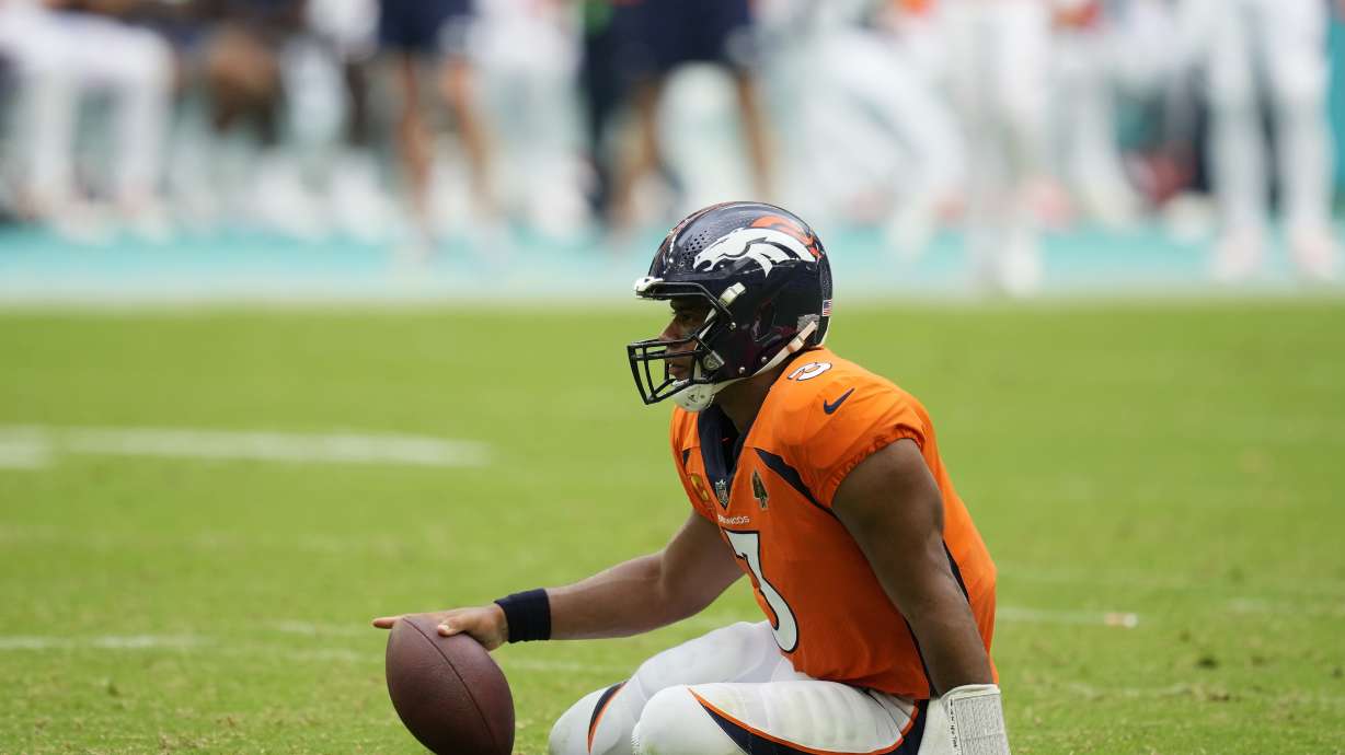 Denver Broncos quarterback Russell Wilson (3) sits on the field after he was sacked during the second half of an NFL football game against the Miami Dolphins, Sunday, Sept. 24, 2023, in Miami Gardens, Fla. The Dolphins defeated the Broncos 70-20.