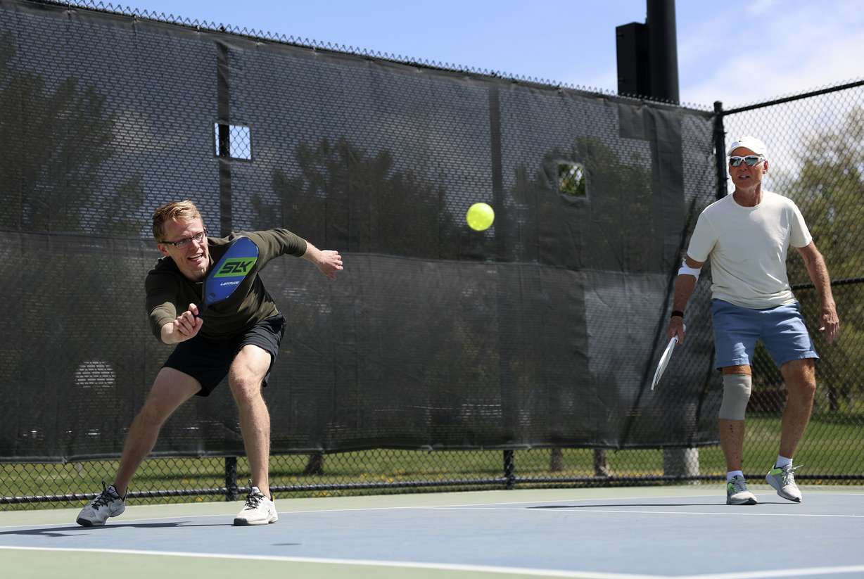 Jason Armstrong, left, and Rick Egan play pickleball at Fairmont Park in Salt Lake City on May 12. Pickleball is growing in popularity in Utah and across the U.S.