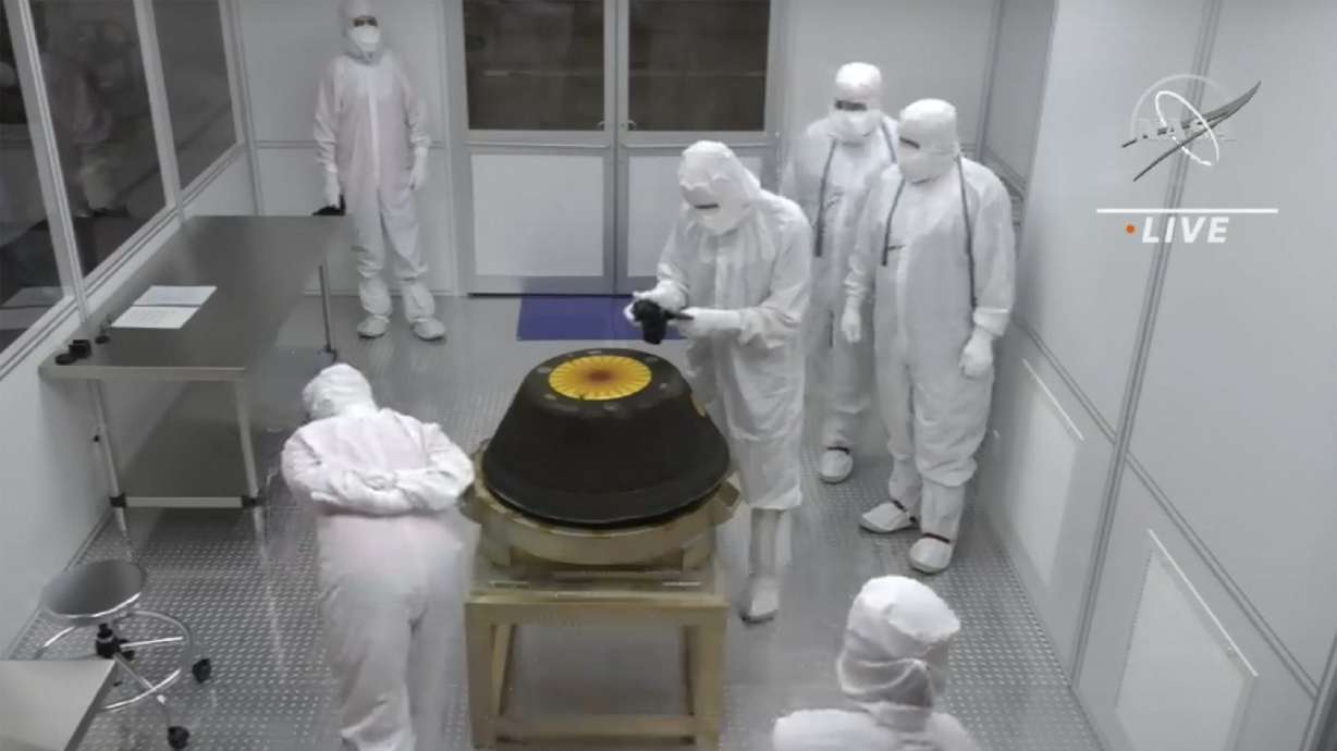 Technicians in a clean room examine the sample return capsule from NASA’s Osiris-Rex mission after it landed at the Utah Test and Training Range on Sunday. The sample was collected from the asteroid Bennu in October 2020.