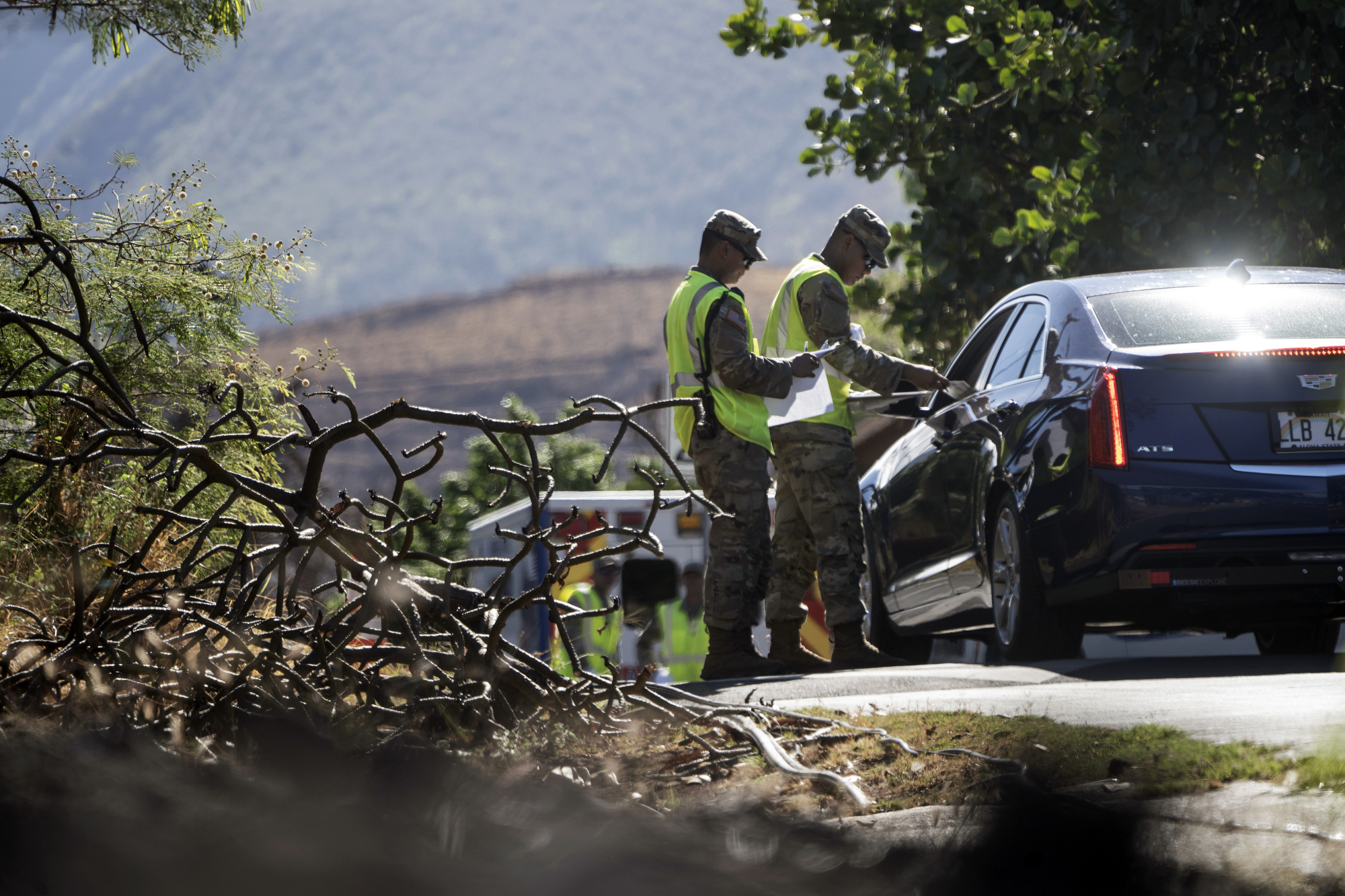 Members of the Hawaii National Guard check on a car passing the checkpoint on Kaniau Road, Monday, in Lahaina, Hawaii. A small group of Lahaina residents returned to their devastated properties Monday for the first time since the Hawaii town was destroyed by wildfire nearly seven weeks earlier.