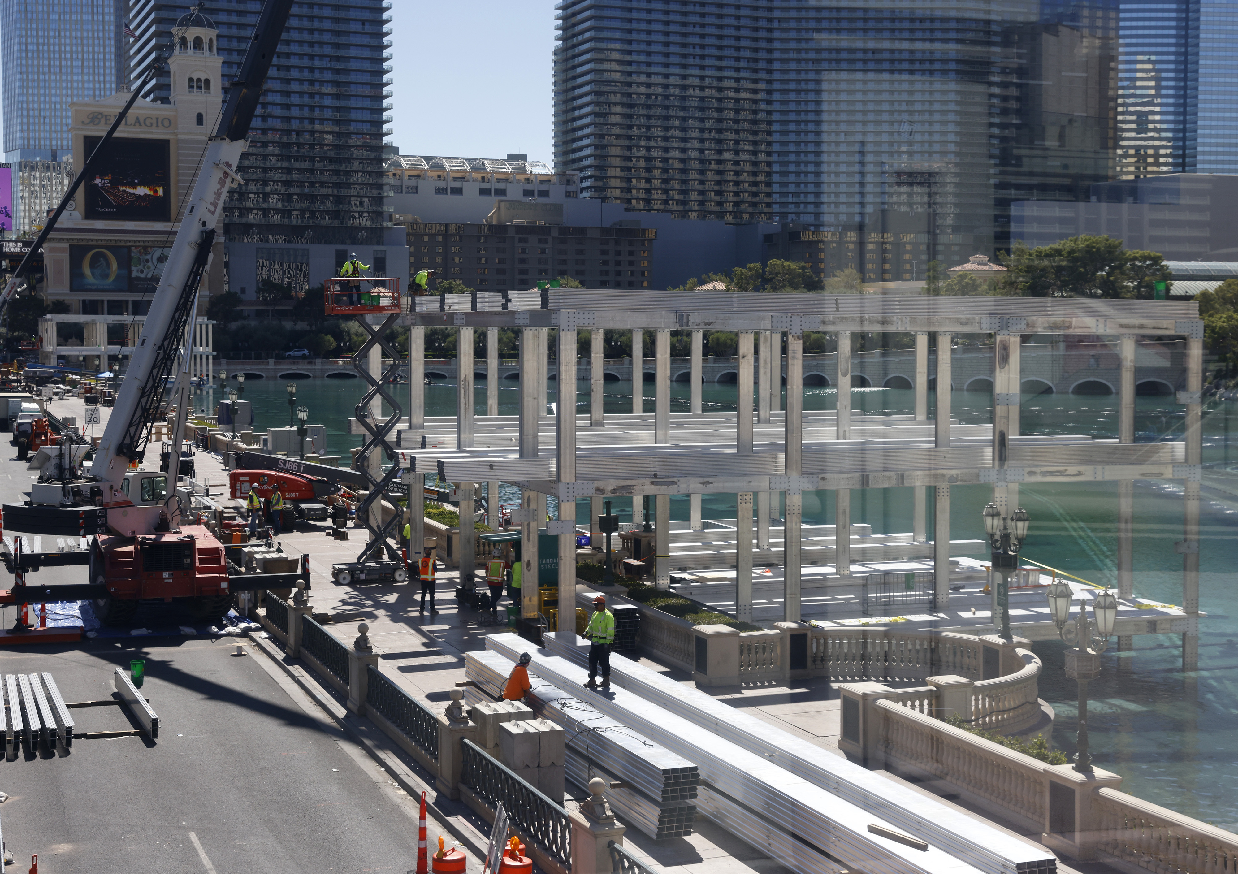 Workers stand at a Formula One construction site at the Bellagio fountains on Monday, Sept. 25, 2023, in Las Vegas. A worker who died during the weekend of an injury received at a temporary Formula One Las Vegas Grand Prix grandstand construction site at the Bellagio resort fountains was identified Monday by authorities.