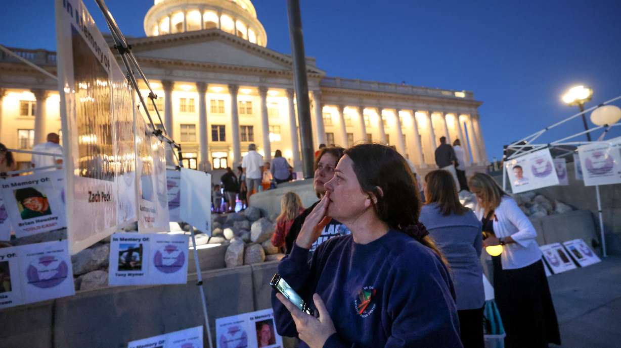 Sommer Funai, front, and Autumn Wagner read about a homicide victim during Utah's National Day of Remembrance for Homicide Victims event outside of the Capitol in Salt Lake City on Sept. 25, 2023.