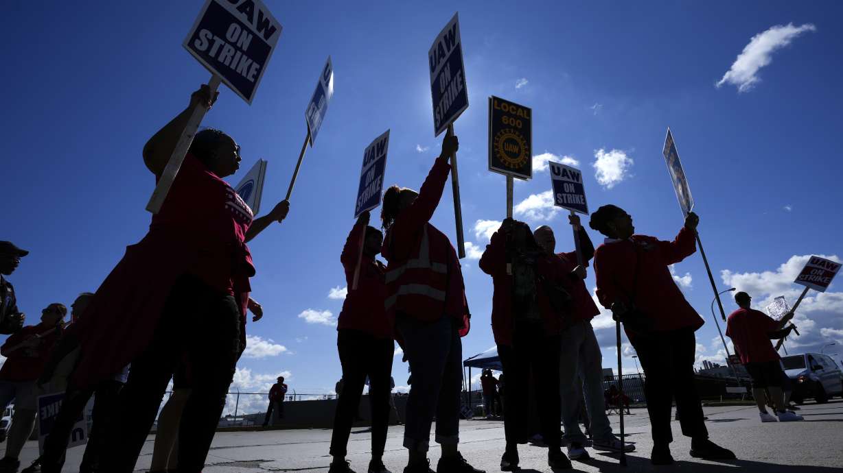 United Auto Workers members walk the picket line at the Ford Michigan Assembly Plant in Wayne, Mich., Sept. 18. President Joe Biden has joined picketing United Auto Workers in Michigan on the 12th day of their strike against major carmakers.