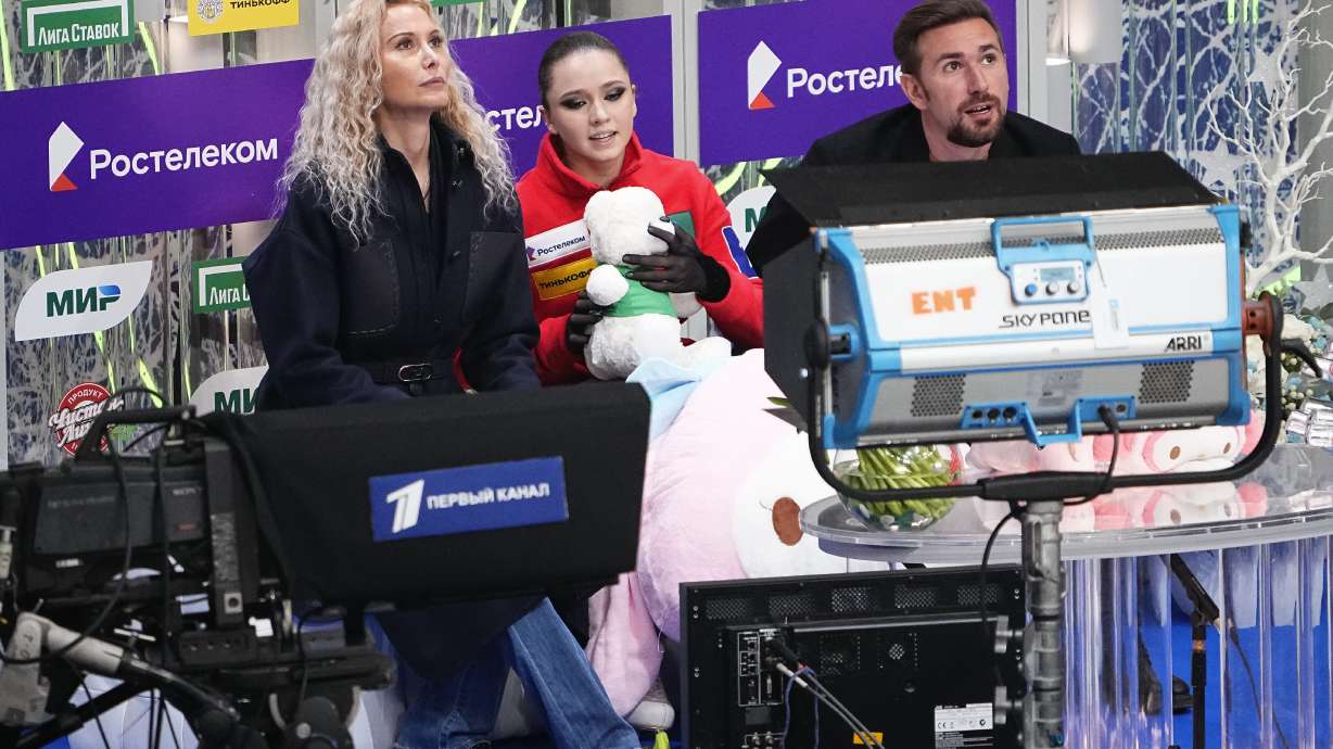 FILE - Russian Kamila Valieva, center, her coach Eteri Tutberidze, left, and choreographer Daniil Gleikhengauz wait for result of her competing in the women's free skate program during the figure skating competition at the 2022 Russian Figure Skating Grand Prix, the Golden Skate of Moscow, at Megasport Arena in Moscow, Russia, on Oct. 23, 2022. The doping case of teenage Russian figure skater Kamila Valieva that shocked the 2022 Beijing Olympics returns to the highest court in sports on Tuesday, Sept. 26, 2023.