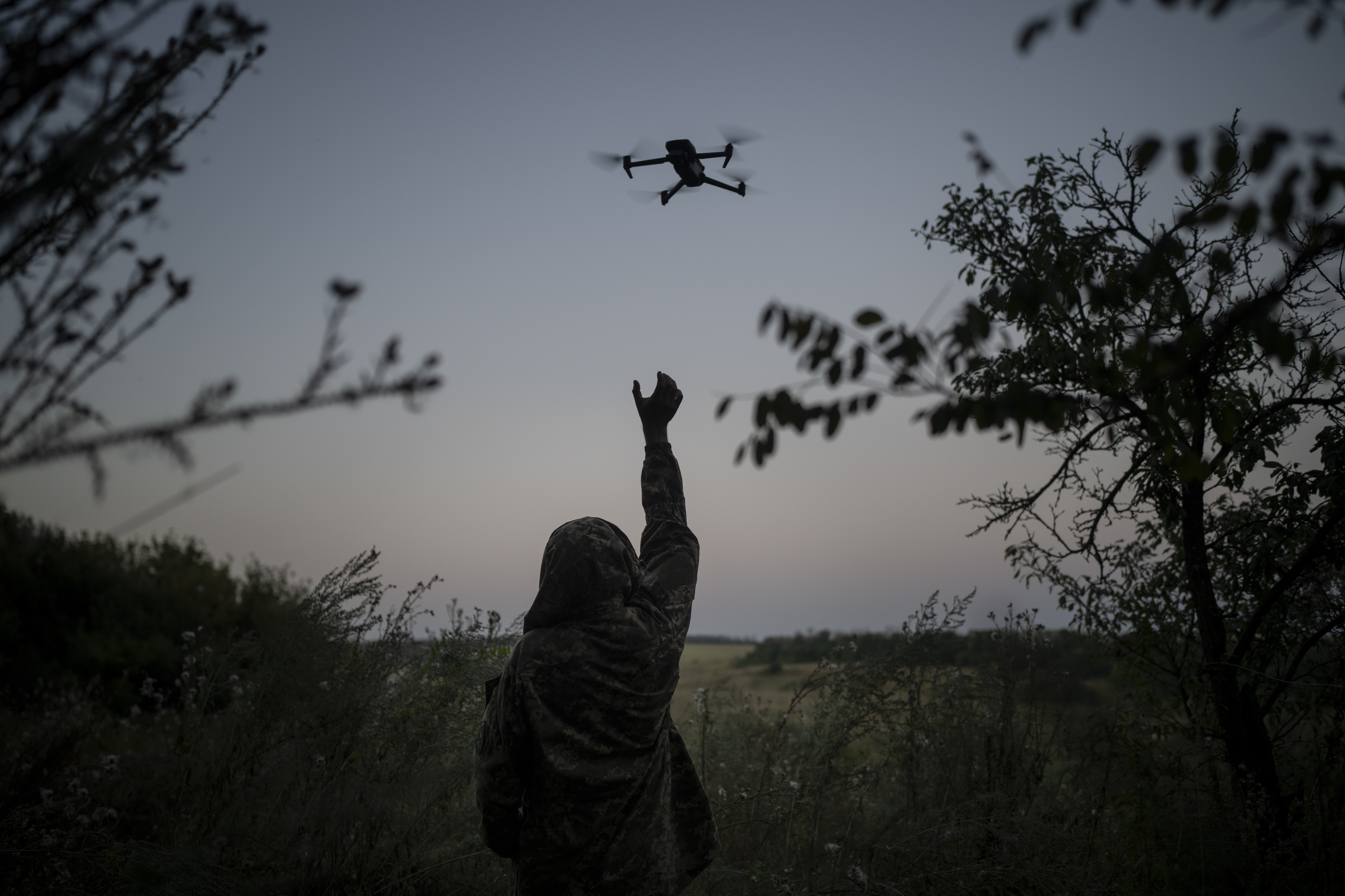 A Ukrainian drone pilot reaches for a reconnaissance drone in the Luhansk Region, Ukraine, Aug. 19. The drone unit's task is to destroy Russia's heavy machinery, armored vehicles and infantry.