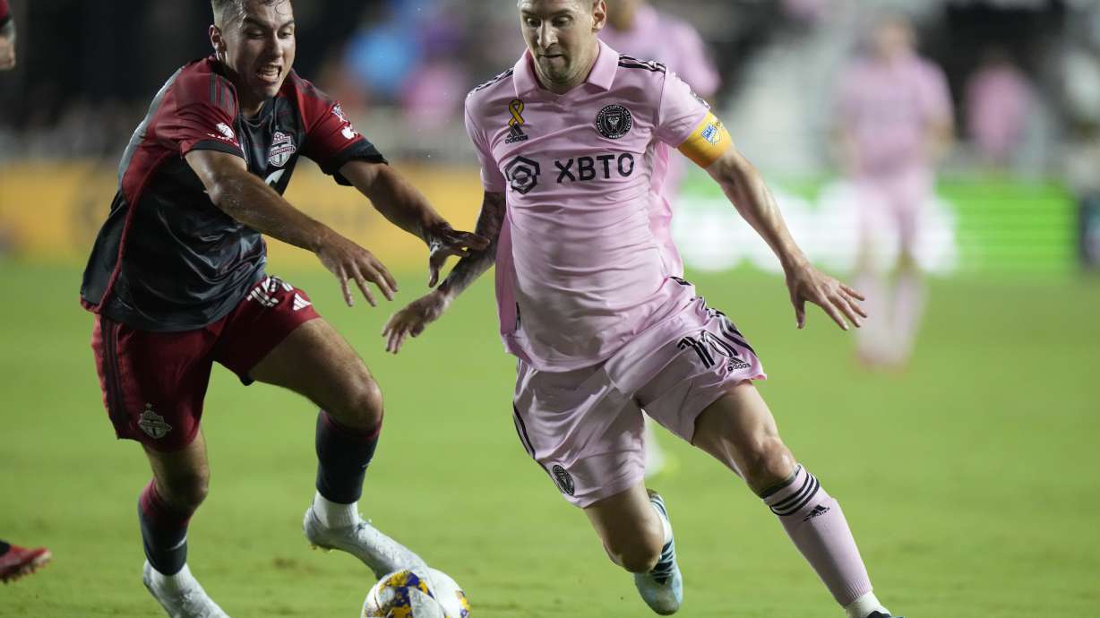 Inter Miami forward Lionel Messi, right, takes the ball past Toronto FC defender Kobe Franklin during the first half of an MLS soccer match, Wednesday, Sept. 20, 2023, in Fort Lauderdale, Fla.