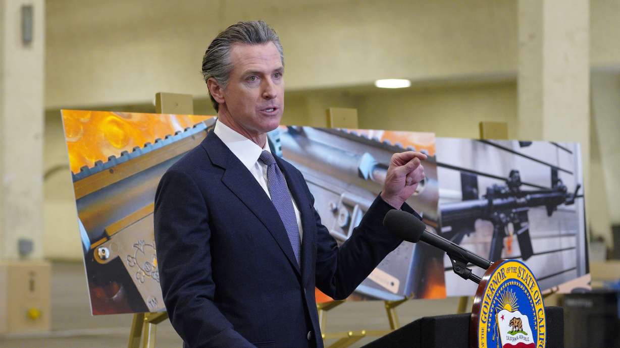 California Gov. Gavin Newsom speaks to reporters at Del Mar Fairgrounds on Feb. 18, 2022, in Del Mar, Calif. Newsom signed a law, Tuesday raising taxes on gun and ammunition sales to pay for school safety and violence prevention.