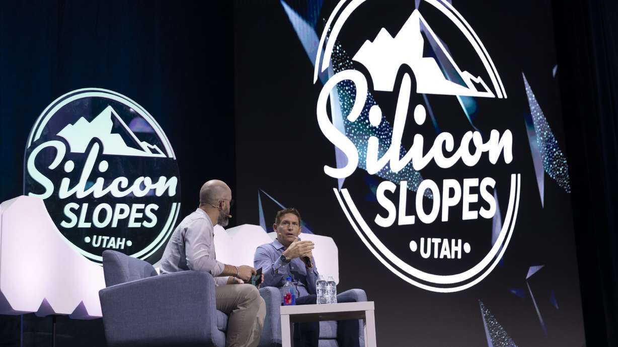 John Bowers, left, director of partnerships at Silicon Slopes, interviews former BYU and NFL quarterback Steve Young, during the Silicon Slopes Summit at Vivint Arena in Salt Lake City on Sept. 30, 2022.
