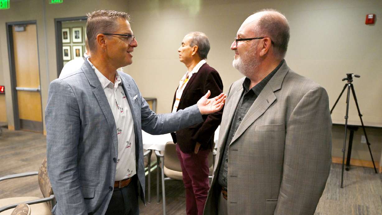 Utah Valley Chamber of Commerce President and CEO Curtis Blair and Utah Hispanic Chamber of Commerce Executive Director Juan Pascua talk during the chamber's reopening in Utah County at the Clyde Companies offices in Orem on Tuesday.
