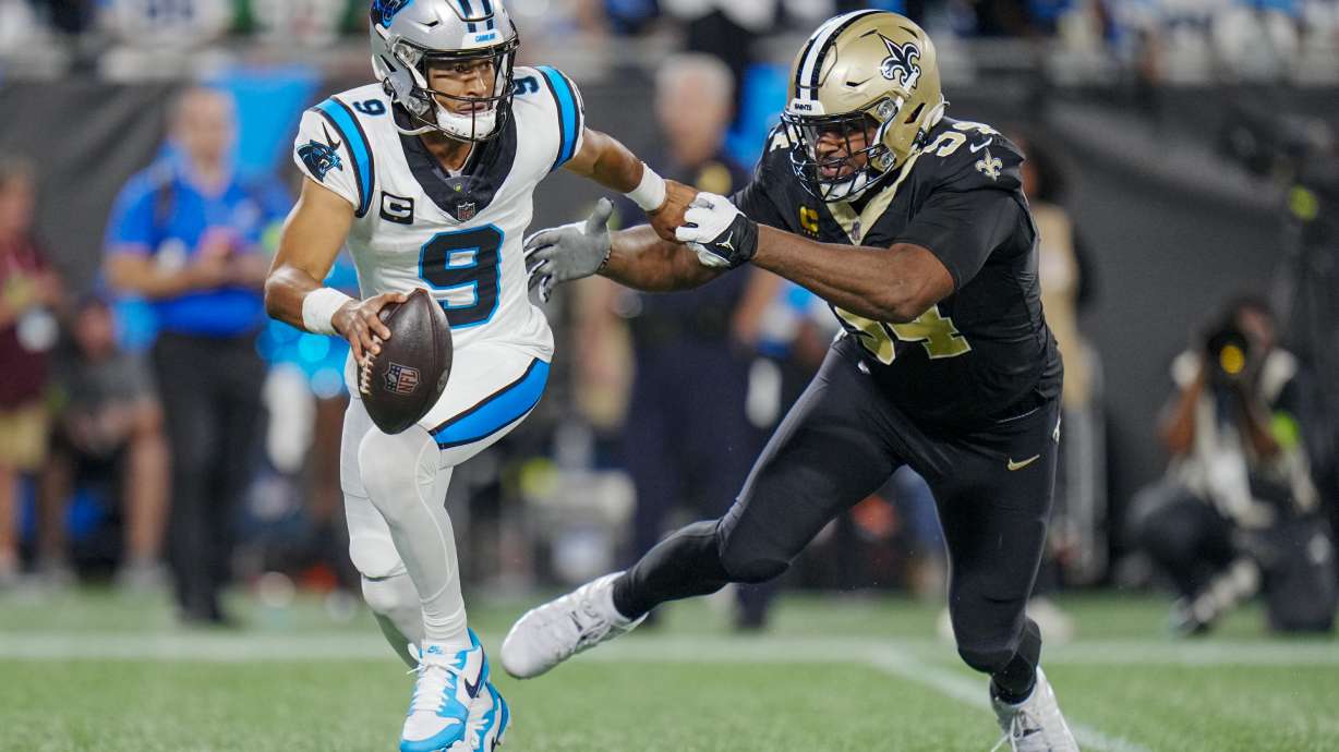 Carolina Panthers quarterback Bryce Young looks to pass under pressure from New Orleans Saints defensive end Cameron Jordan during the first half of an NFL football game Monday, Sept. 18, 2023, in Charlotte, N.C.