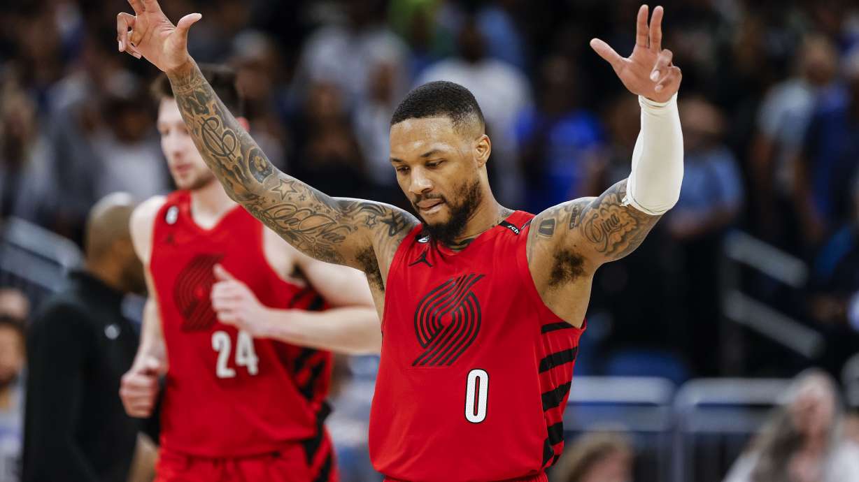 FILE - Portland Trail Blazers guard Damian Lillard (0) celebrates after a shot against the Orlando Magic during the second half of an NBA basketball game, Sunday, March 5, 2023, in Orlando, Fla. Lillard is being traded by Portland to play alongside Giannis Antetokounmpo in Milwaukee, a person with knowledge of the agreement said Wednesday, Sept. 27, 2023, a move that ends a three-month saga surrounding his wish to be moved elsewhere with hopes of winning an NBA title and ending his 11-year run with the Trail Blazers.