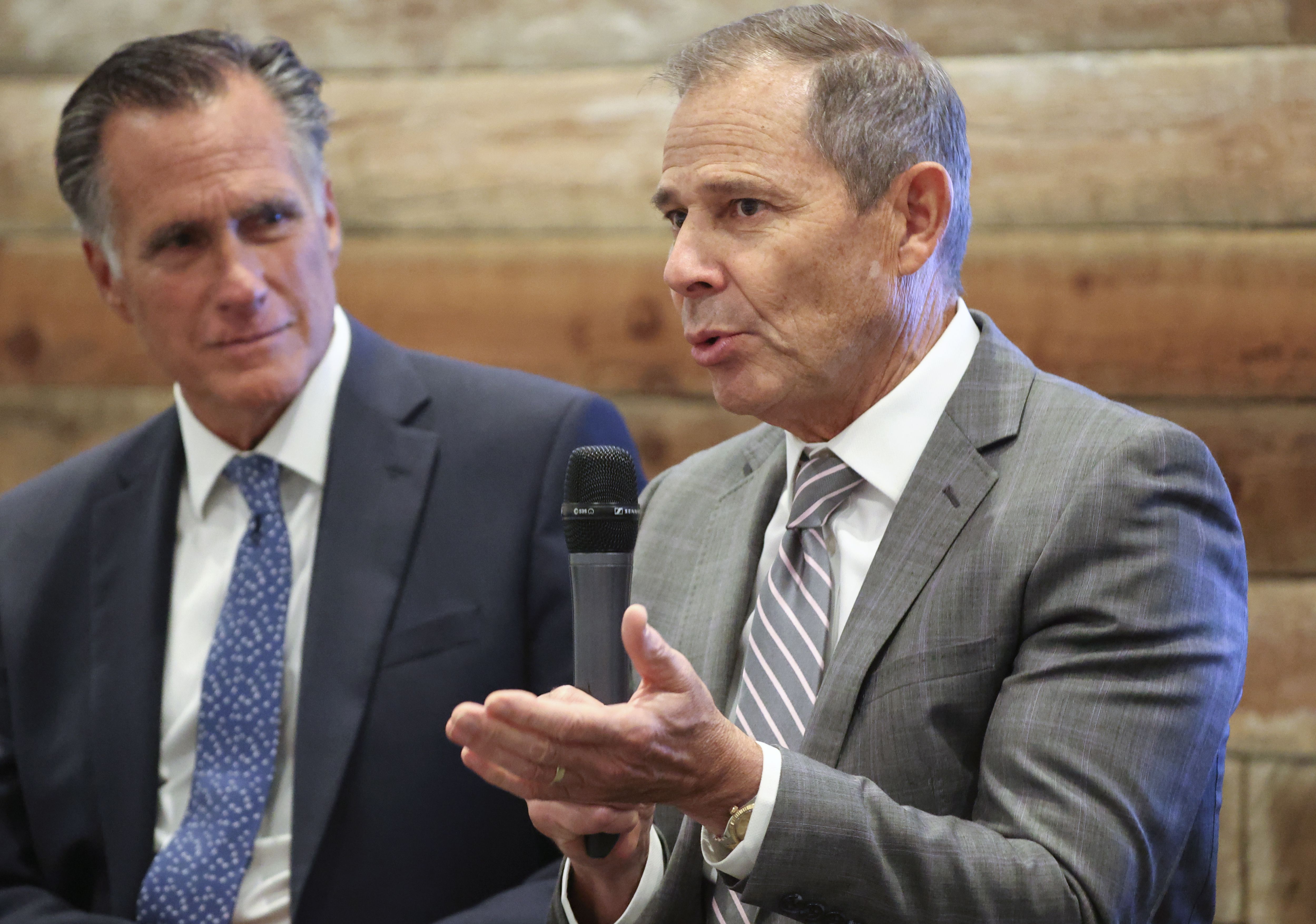 Sen. Mitt Romney, R-Utah, listens to Rep. John Curtis, R-Utah, during a South Valley Chamber of Commerce meeting at Salt Mine Productive in Sandy on Aug. 18, 2022. After Romney said he wasn’t running for reelection, several potential candidates have shown interest in the seat.