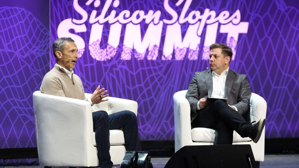 Jimmy Pitaro, chairman of ESPN, and Steve Starks, the CEO of Larry H. Miller Company, speak at the eighth annual Silicon Slopes Summit at the Delta Center in Salt Lake City on Wednesday.