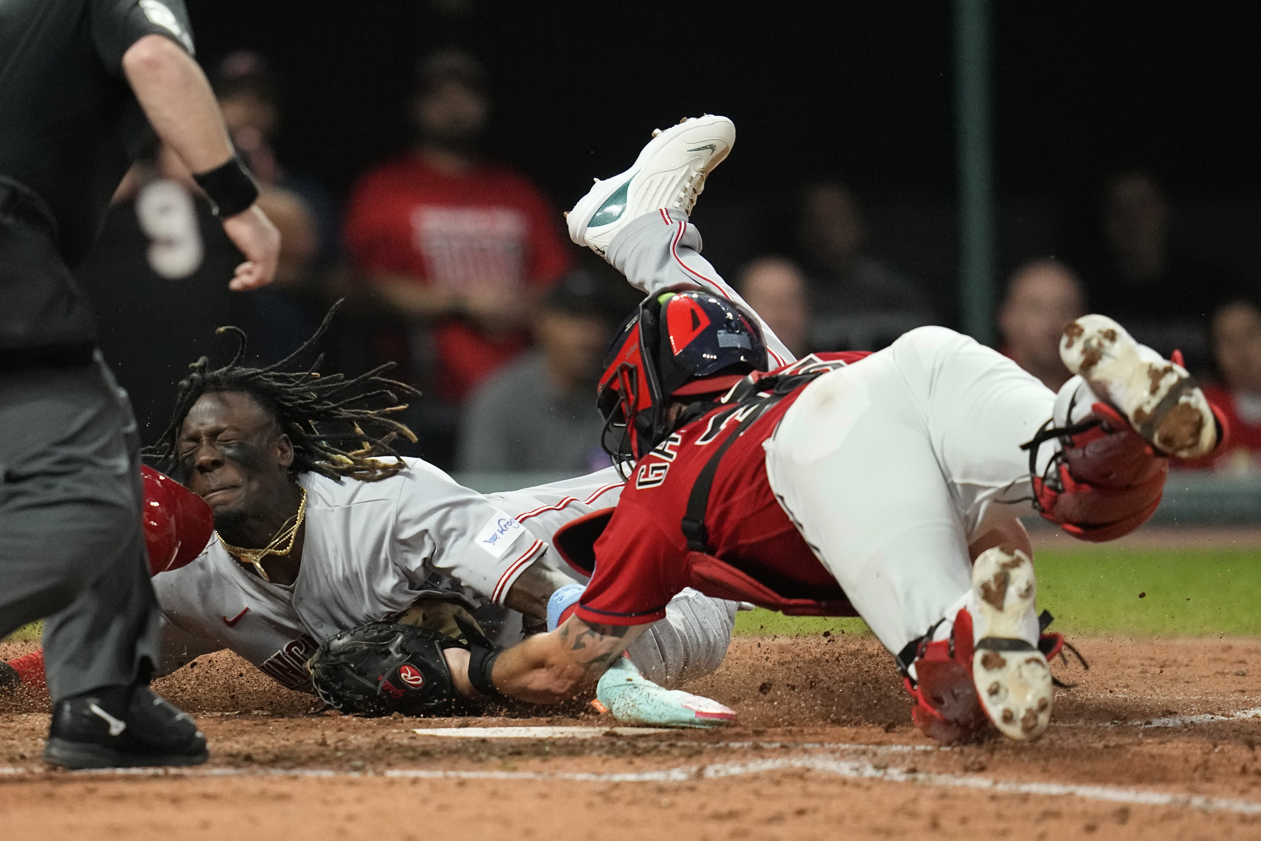 Cincinnati Reds' Elly De La Cruz, left, is tagged out at home by Cleveland Guardians catcher Cam Gallagher duirng the fifth inning of a baseball game Wednesday, Sept. 27, 2023, in Cleveland.