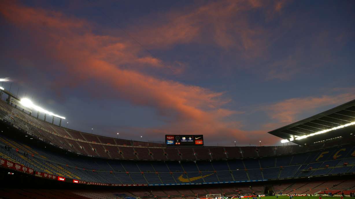 FILE - A general view of the the Camp Nou stadium as the sun sets ahead of the Spanish La Liga soccer match between FC Barcelona and Valladolid CF in Barcelona, Spain, on April 5, 2021. Spanish police raided offices of the Spanish soccer federation on Thursday Sept. 28, 2023 as part of a judicial investigation into the alleged payment of millions of euros over several years by Barcelona soccer club to the vice president of Spain’s football refereeing committee.