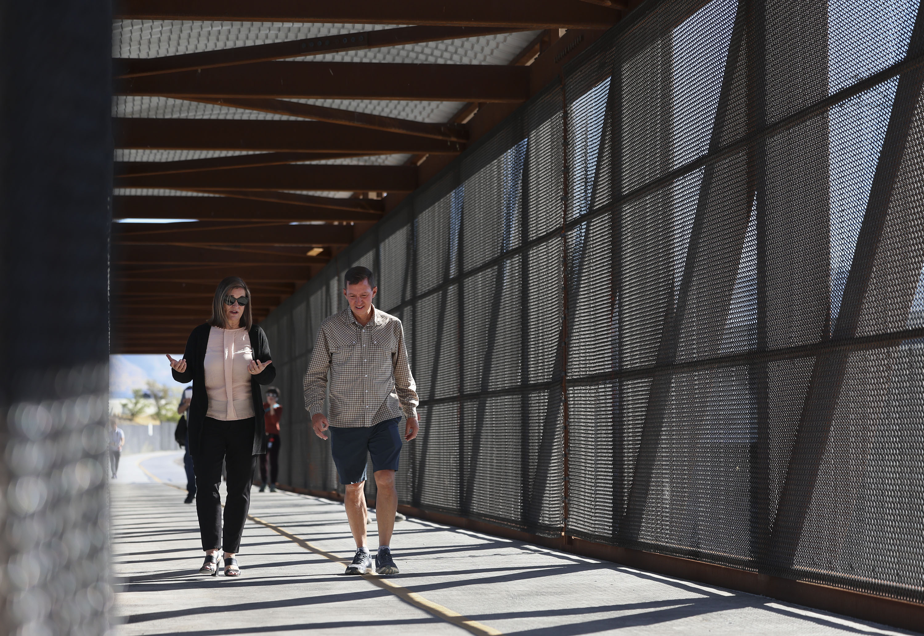 Salt Lake County Mayor Jenny Wilson and Trails and Tunnels Chairman Juan Arce-Larreta walk across a bridge over the Jordan River section of Parleys Trail in West Valley on Thursday. The primarily elevated section of Parleys Trail, from 900 West to Jordan River Parkway, is complete and officially open to the public.