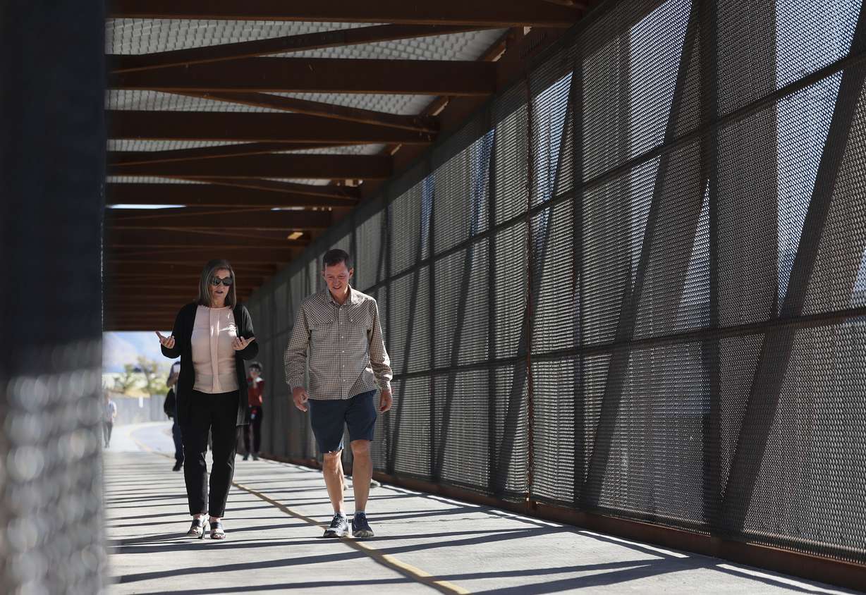 Salt Lake County Mayor Jenny Wilson and Trails and Tunnels Chairman Juan Arce-Larreta walk across a bridge over the Jordan River section of Parleys Trail in West Valley on Thursday. The primarily elevated section of Parleys Trail, from 900 West to Jordan River Parkway, is complete and officially open to the public.