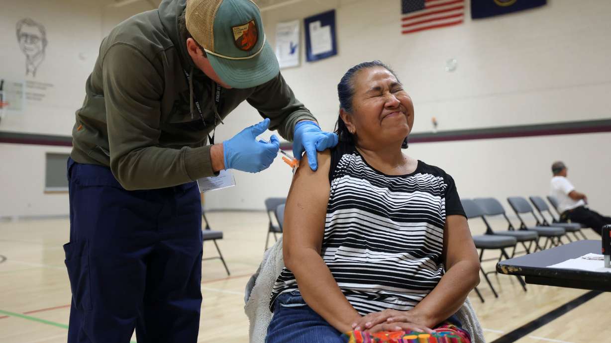 Ana Enriquez gets a Moderna COVID-19 booster shot during a free vaccine clinic at the Sanderson Community Center in Taylorsville on Nov. 9, 2022. Now that the federal government has given the go-ahead for everyone six months and older to get the newly updated COVID-19 vaccine, how should the shots be timed?