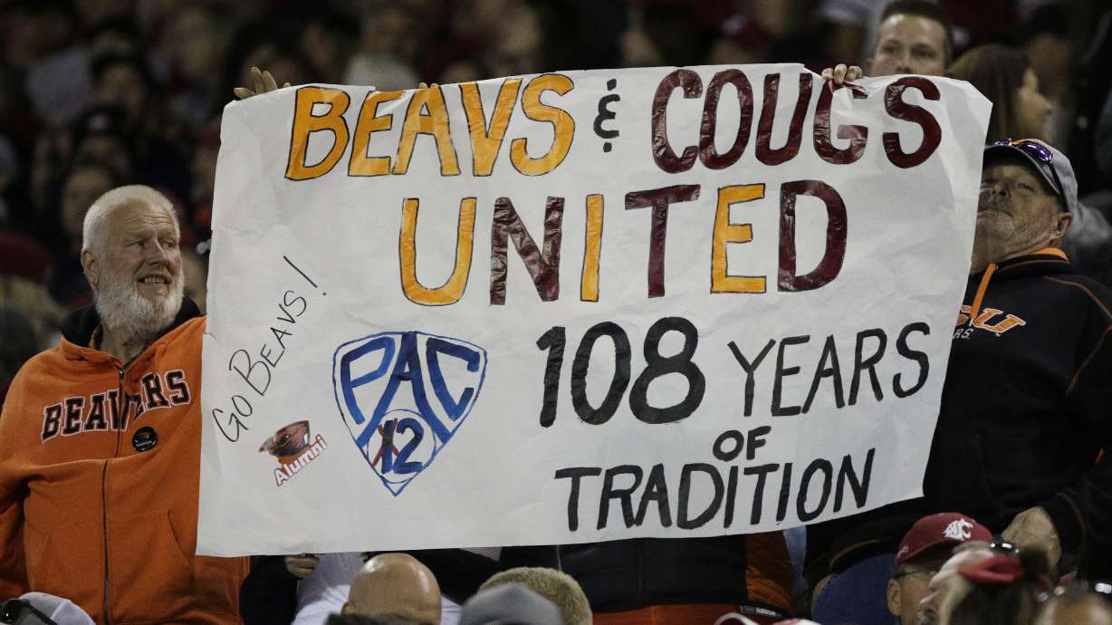 An Oregon State fans hold a "Pac-2" sign, representing the two schools that will remain in the Pac-12 after the 2023-2024 academic year after the other schools in the conference announced plans to leave, during the second half of an NCAA college football game between Washington State and Oregon State, Saturday, Sept. 23, 2023, in Pullman, Wash.