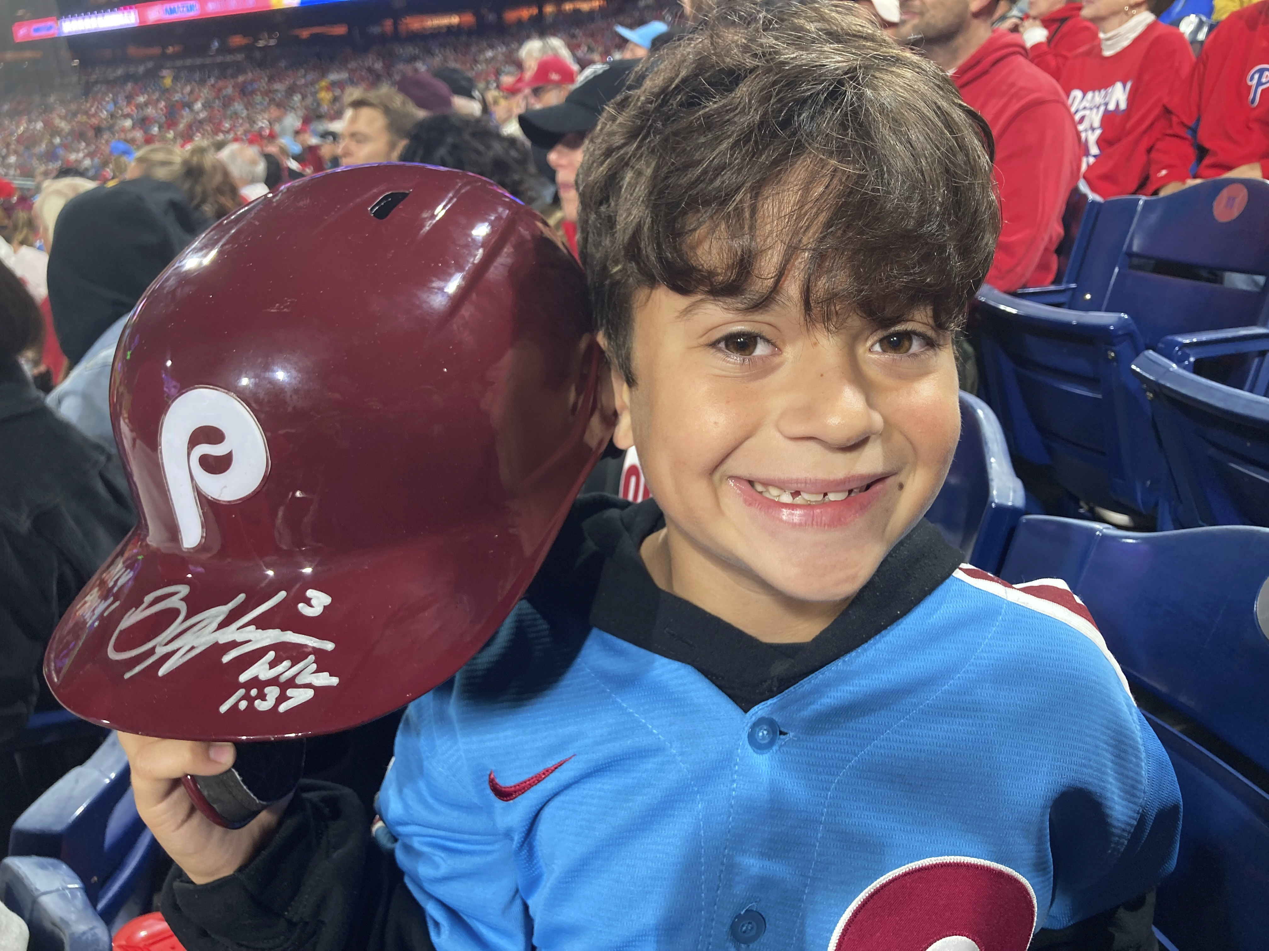 Hayden Dorfman, 10, of Voorhees, N.J., holds up Philadelphia Phillies slugger Bryce Harper’s autographed helmet during a baseball game against the Pittsburgh Pirates, Thursday, Sept. 28, 2023, in Philadelphia. Harper tossed his helmet into the stands after he was ejected and it was retrieved by Dorfman.