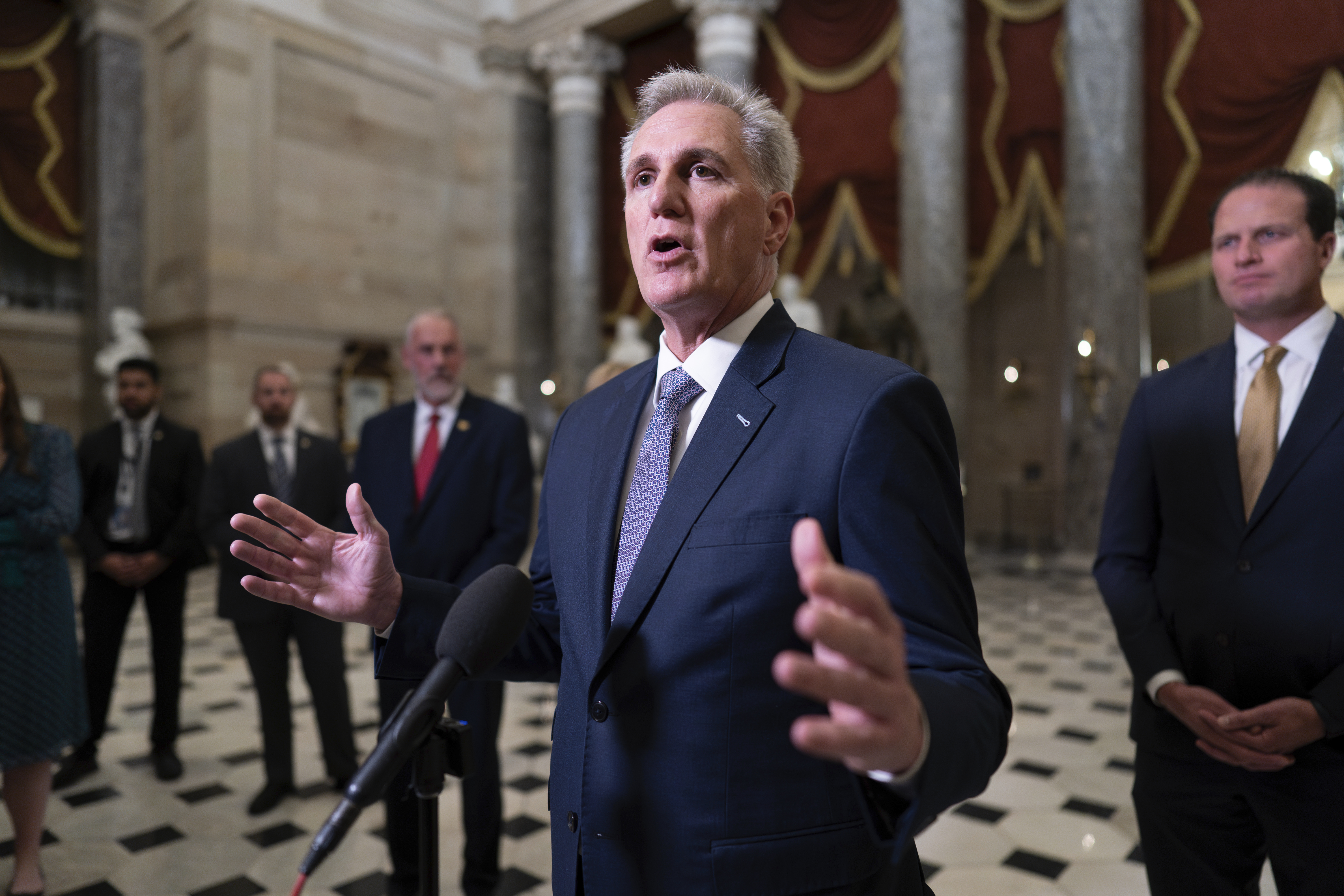 House Speaker Kevin McCarthy, R-Calif., joined by Rep. August Pfluger, R-Texas, right, and other GOP members, talks to reporters just after voting to advance appropriations bills on the House floor, at the Capitol in Washington, Tuesday night. McCarthy is digging in on his refusal to take up Senate legislation designed to keep the federal government fully running beyond midnight Saturday.