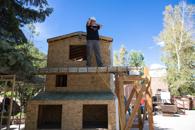 Ryley Benson, a sophomore, adjusts his helmet. It takes approximately three months for the woodworking students to complete a tiny home.