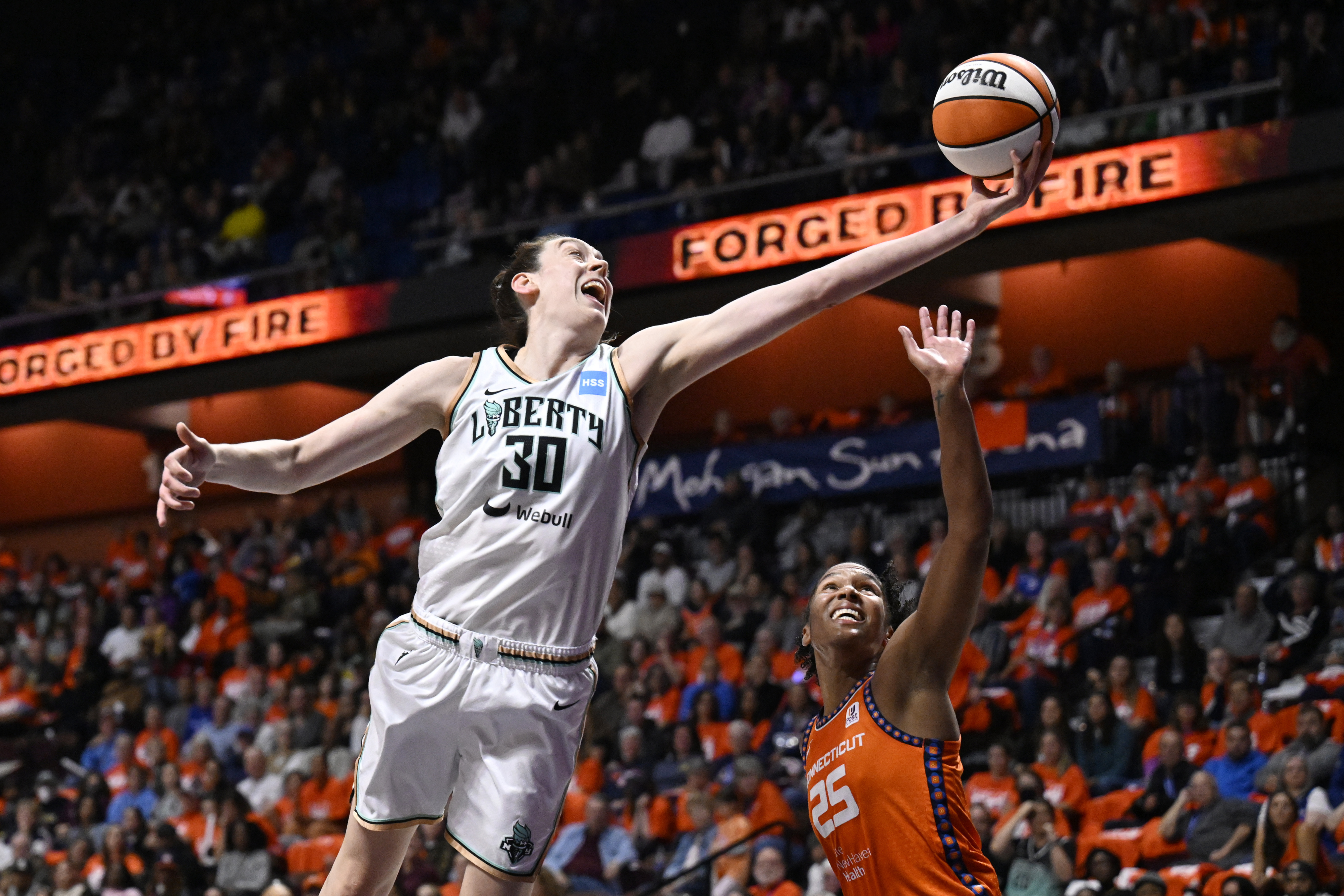 New York Liberty forward Breanna Stewart (30) reaches for a rebound against Connecticut Sun forward Alyssa Thomas (25) during the first half of Game 3 of a WNBA basketball semifinal playoff series Friday, Sept. 29, 2023, in Uncasville, Conn.