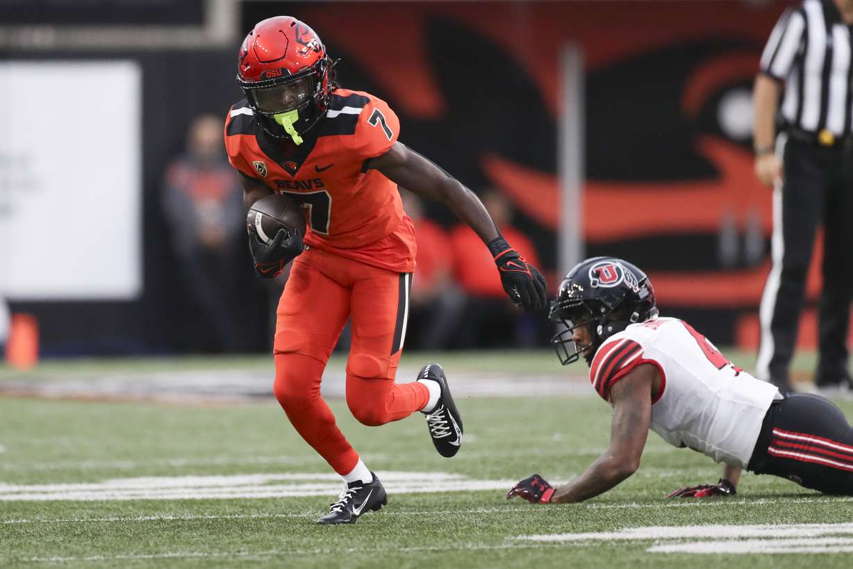 Oregon State wide receiver Silas Bolden (7) dodges Utah cornerback JaTravis Broughton (4) during the first half of an NCAA college football game Friday, Sept. 29, 2023, in Corvallis, Ore.