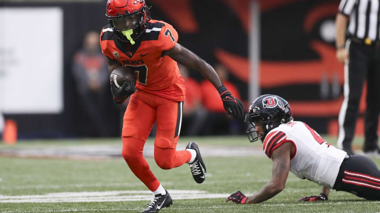 Oregon State wide receiver Silas Bolden (7) dodges Utah cornerback JaTravis Broughton (4) during the first half of an NCAA college football game Friday, Sept. 29, 2023, in Corvallis, Ore.